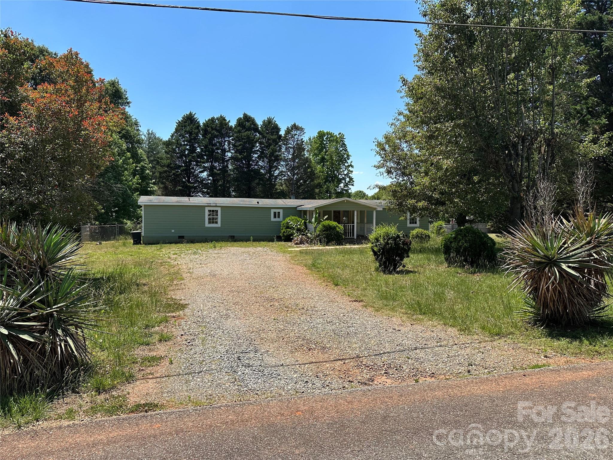 Don't blink or this steal will be GONE! Well-maintained single-wide mobile home in peaceful community. Sits on slightly more than 1/2 acre of land, with the back yard being fenced. Could also be an investment property with rental potential.