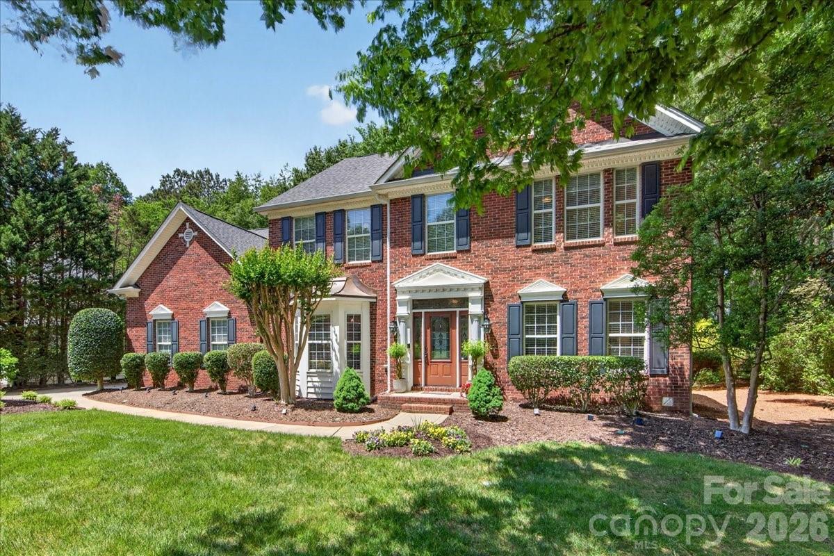 Custom-built home in the coveted Overlook community, complete with your own Deeded Boat Slip and Lift on Mountain Island Lake. Meticulously maintained and thoughtfully upgraded by the original owners — including a new Primary Bath (2025), new HVAC systems (2024), and a new roof (2020) — this full-brick home offers true peace of mind from day one.  The main level showcases rich hardwood floors throughout, a gas-log fireplace, and a chef-inspired Kitchen featuring granite countertops, a prep island, bar-height breakfast bar, pantry, dry bar, and stainless steel appliances — all open to the large Family Room and sun-filled Breakfast Area. Step through to the entertainer's Deck overlooking a private, tree-buffered backyard with in-ground irrigation and lush mature landscaping. A Butler's passage leads to the formal Dining Room, while the Formal Living Room and a versatile flex space — perfect as an Office/Study, Hobby Room, or even a guest BR — complete the main level.  Front and rear staircases add everyday convenience.  Upstairs, the expansive Primary Suite features a beautifully remodeled private bath with garden tub, walk-in shower, and dual sinks, plus 2 spacious walk-in closets. Three additional bedrooms, a second full bath, a large Bonus Room with walk-in attic storage, and a dedicated Laundry room provide space for everyone.  Just steps from your back deck, you are a 2 minute walk on a community sidewalk from your own boat slip — evening cruises on the lake await. The side-load 3-car garage provides utility and storage.  The amenity rich neighborhood includes clubhouse, recreation courts, playgrounds, and the wide tree-lined streets with sidewalks that make Overlook one of the area's most sought-after addresses. Minutes from schools, shopping, dining, healthcare, and an easy commute to Charlotte, the Airport, and the Whitewater Center.
