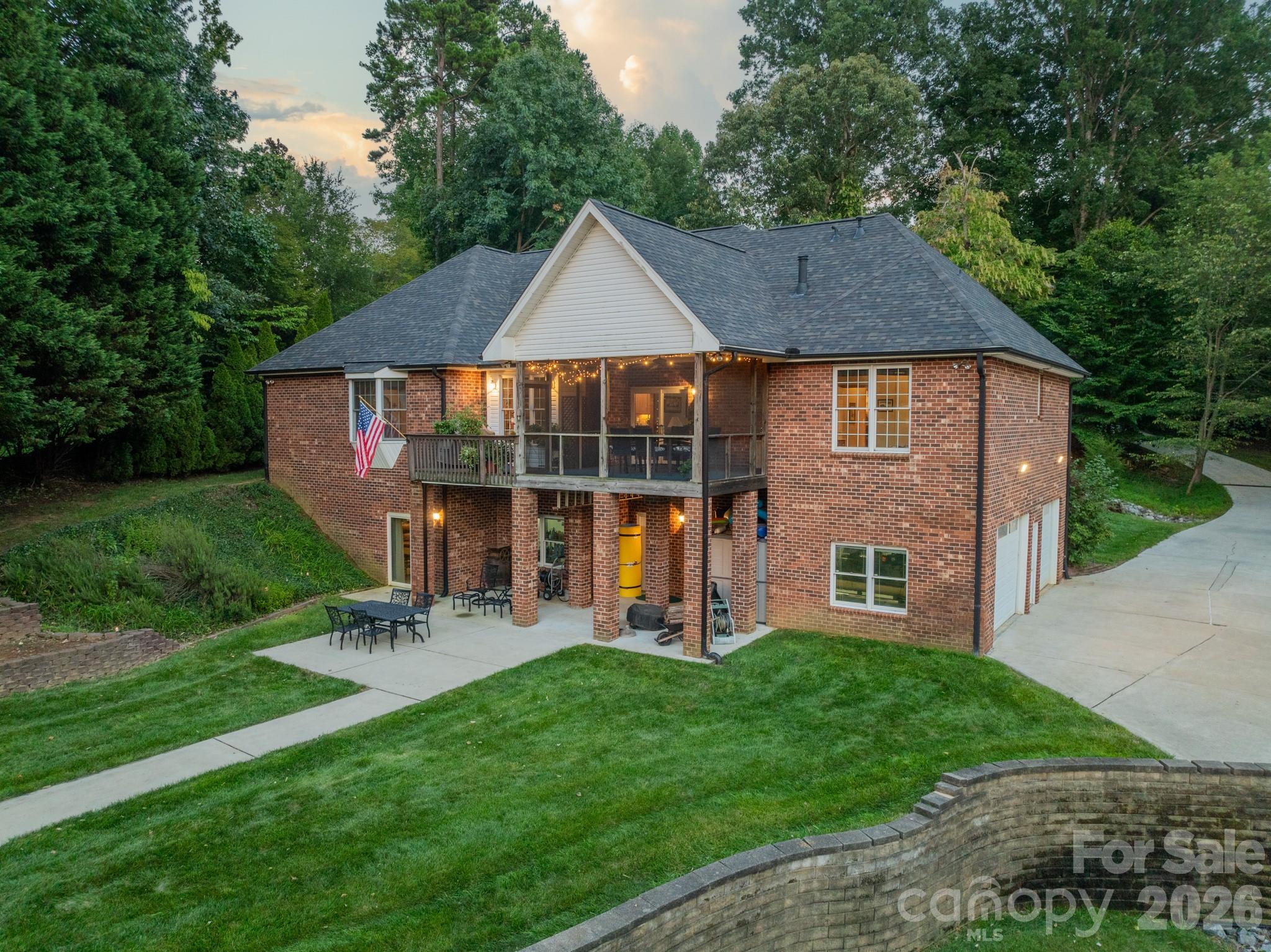 Set on one of the most picturesque deep-water lots on Lake Norman, this custom owner-built full brick waterfront estate offers an exceptional blend of luxury, privacy, and lakefront living. Nestled within a quiet no-HOA community where short-term rentals are permitted, this property presents a rare opportunity for both personal enjoyment and investment potential.

Thoughtfully positioned in a private cove with immediate access to the main channel, the home showcases a beautifully dredged shoreline, an impressive engineered retaining wall, and a gentle approach to the water’s edge — creating an ideal setting for year-round enjoyment on the lake.

Designed for elevated outdoor living, the property features lake-fed irrigation, a custom dock and expansive deck with boat lift, dual driveways, and exceptional parking capacity. The boat is also available for purchase separately.

Inside, the meticulously maintained residence offers generous living spaces with four spacious bedrooms, a large bonus room above the garage, a walk-out basement, and a screened porch perfectly positioned for peaceful waterfront views. The recently renovated owner’s suite bath delivers a spa-inspired experience with a luxurious oversized walk-in shower.

Car collectors, hobbyists, and boating enthusiasts alike will appreciate the rare six-car garage capacity, complete with a Tesla charging station and a fully insulated workshop/auto bay featuring poly-steel construction with impressive R-50 insulation performance. The workshop also includes a convenient half bath, sediment filtration systems, and water softening equipment.

Additional highlights include a spacious recreation area with pool table included, a 2024 roof, and countless thoughtful custom details throughout. Septic permit is for three bedrooms; home is currently configured as four bedrooms.

A truly exceptional waterfront retreat offering craftsmanship, functionality, and the lifestyle Lake Norman is known for.