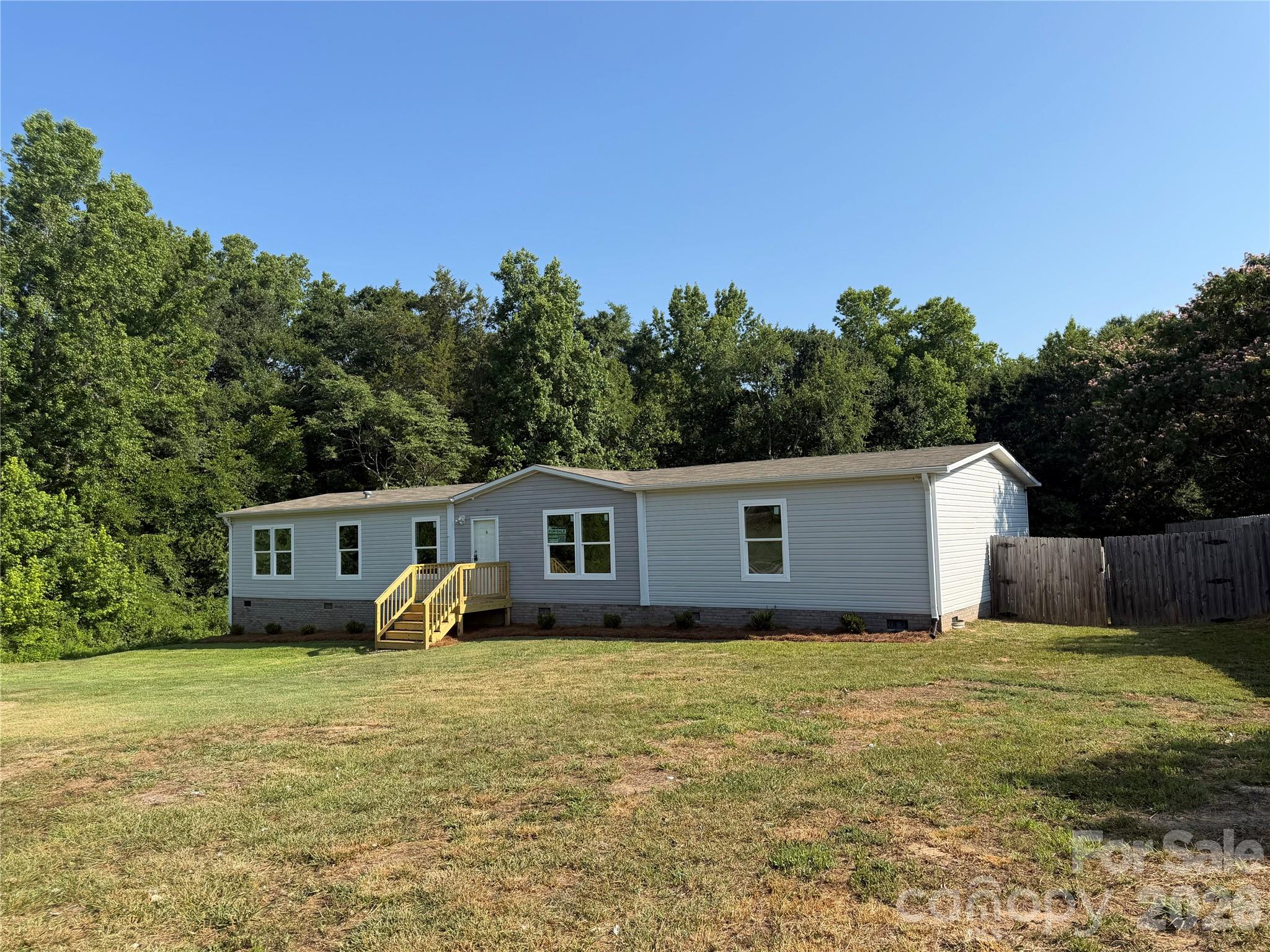 Nice! 2018 Year Model Approximately 2026 Sq Ft Clayton Manufactured Home. Modern Open Floor Plan with Large Living Room with Entertainment Wall, Dining Area,  Island Kitchen with Range, Refrigerator and Dishwasher, Barn Door Style Pantry, Laundry Room with Linen Cabinet, Primary Bedroom and Bath with Dual Sinks Vanity, Soaker Tub, Separate Shower, Linen Shelves and Walk in Closet. Central Heat and Air, Permanent Foundation, Brick Underpinned, Public Water, Private Septic, 2.84 Acres!