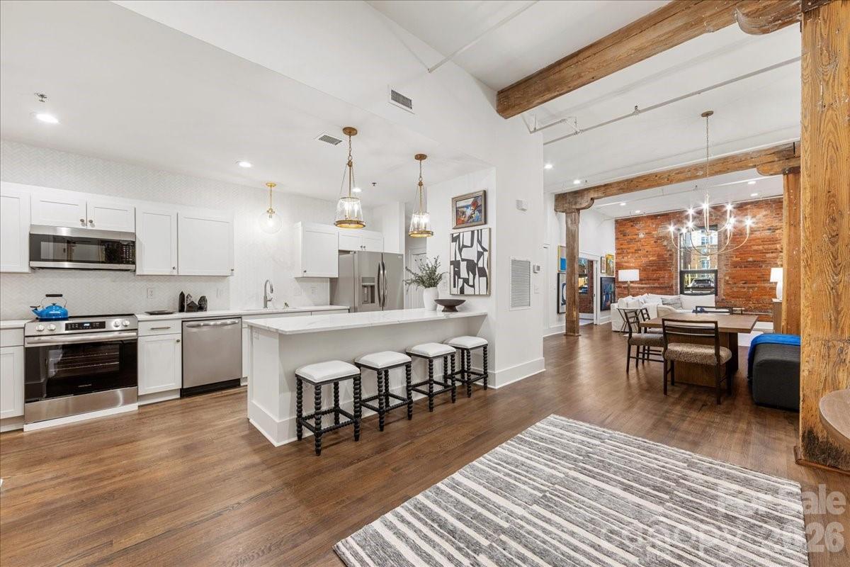 Chic, Historic, and Exceptionally Rare — A True South End Gem!

Welcome to an extraordinary, designer-renovated residence in Factory Lofts, one of Charlotte’s most iconic and coveted buildings—formerly the historic Lance Cracker Factory and now home to just 50 exclusive residences. Set in the heart of South End, Charlotte’s hottest and most dynamic neighborhood, this home blends industrial heritage with refined, designer-level sophistication. 

This true one-bedroom plus custom built-in Murphy Bed was gut-renovated by an internationally known interior designer as her personal residence, resulting in a level of craftsmanship and finish rarely seen in the market. Soaring 15' ceilings, refinished hardwood floors, a stunning Thassos marble backsplash in the kitchen, and a Carrara marble bathroom countertop set a timeless, elevated tone throughout. Thoughtfully designed custom closets maximize storage, while curated lighting by Visual Comfort adds warmth and architectural drama. The loft-like layout offers exceptional versatility—perfect as a primary residence, pied-à-terre, or income-producing investment. Even more rare, Factory Lofts is one of Charlotte’s only true LIVE/WORK buildings, allowing you to operate a boutique business, studio, or office directly from the unit. Additional highlights include gated parking, separate storage, and abundant original factory details that celebrate the building’s historic character.

Stylish, flexible, and truly one of a kind—this is South End living at its finest.