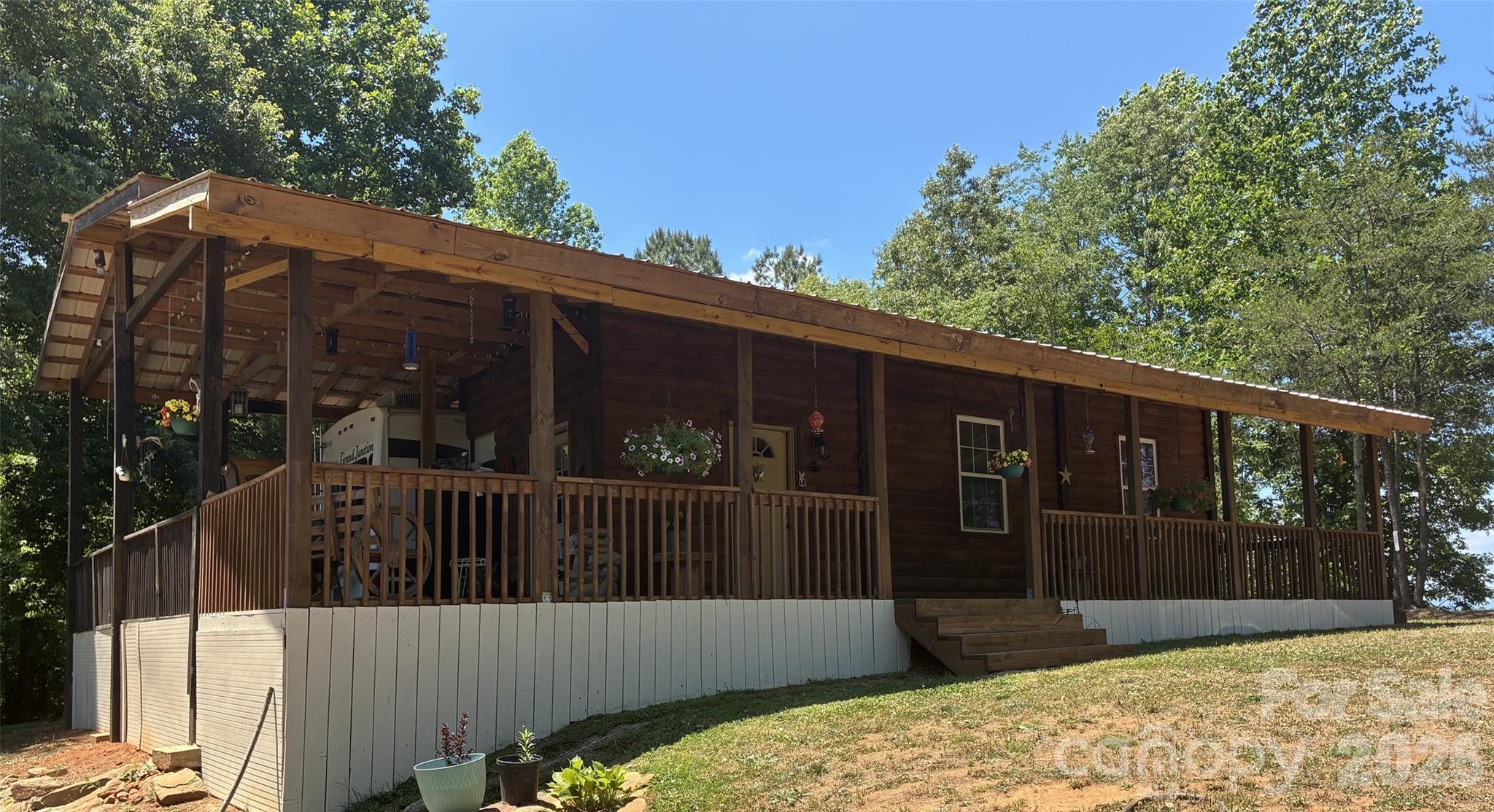 Discover your own mountain retreat on 10.74 acres featuring long-range mountain views, a bold creek, and multiple improvements already in place. This property includes an RV with a full addition, a protective cover built over the RV, a covered porch, two storage buildings, a private well, and a septic system. The added room provides extra living space, making the property comfortable for full-time living, weekend getaways, or short-term rental use. With gentle land, privacy, and year-round views, the possibilities are endless—live on-site while you build your dream home, enjoy it as a vacation property, or split your time between this peaceful mountain escape and your primary residence. A rare opportunity with infrastructure already established and natural beauty all around