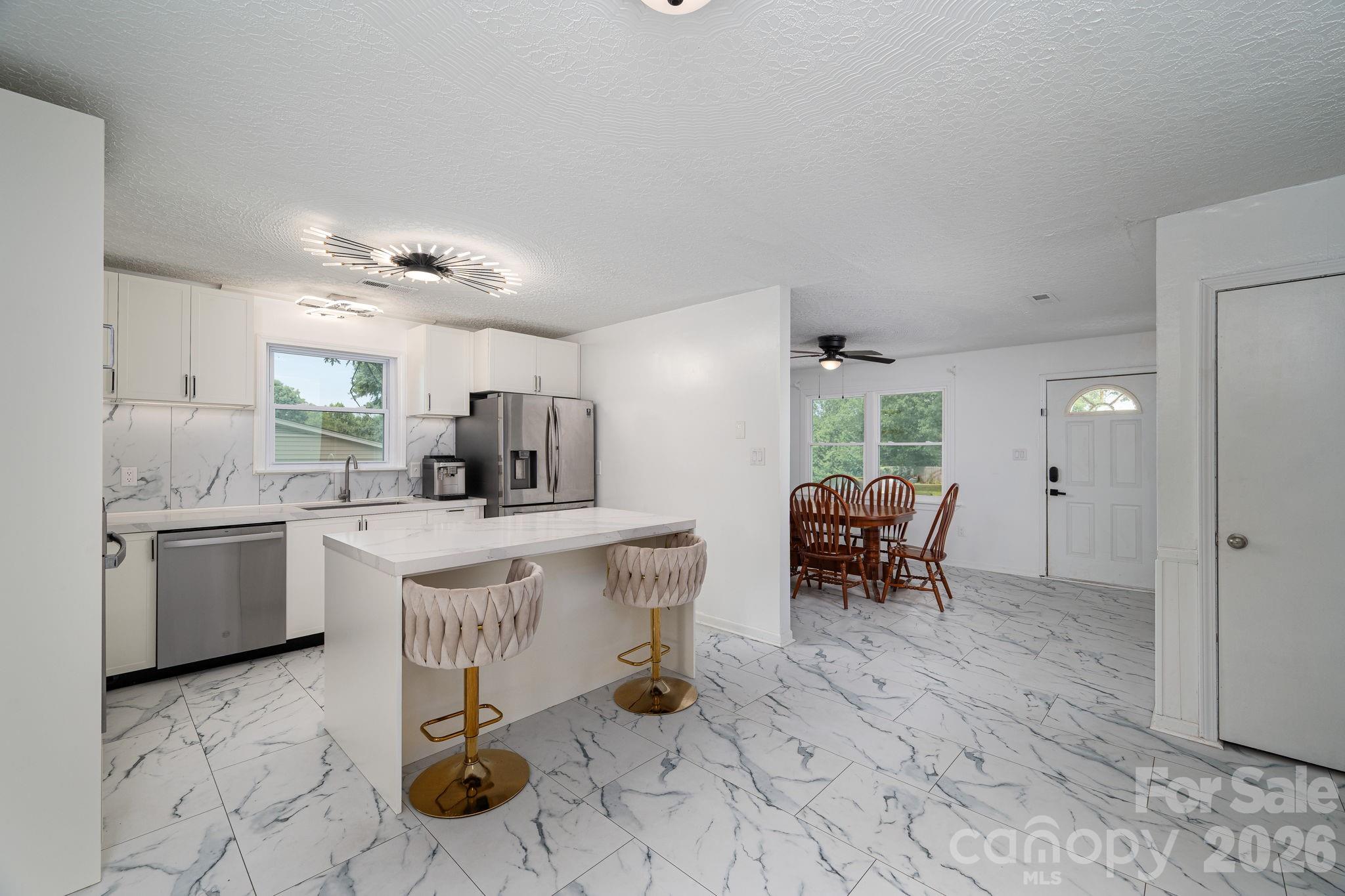 Welcome to 363 Don McGinnis Rd in Lincolnton! This 3 Bed 2 Bath home has been tastefully renovated inside. The kitchen features custom designed soft-close cabinets with quartz countertops throughout as well as all new stainless steel appliances, including the fridge! Both bathrooms have been fully updated with vinyl tile, modern fixtures, and quarts countertops. High end motion activated bidet's in each bathroom and washer and dryer included in the main hall bathroom as well! Home is just beyond the Lincolnton town square, just minutes from all the fine dining and activities that Lincolnton has to offer. Just down the highway, this home is central to Hickory, Gastonia, Denver, Mooresville, and still within commuting distance to Charlotte!