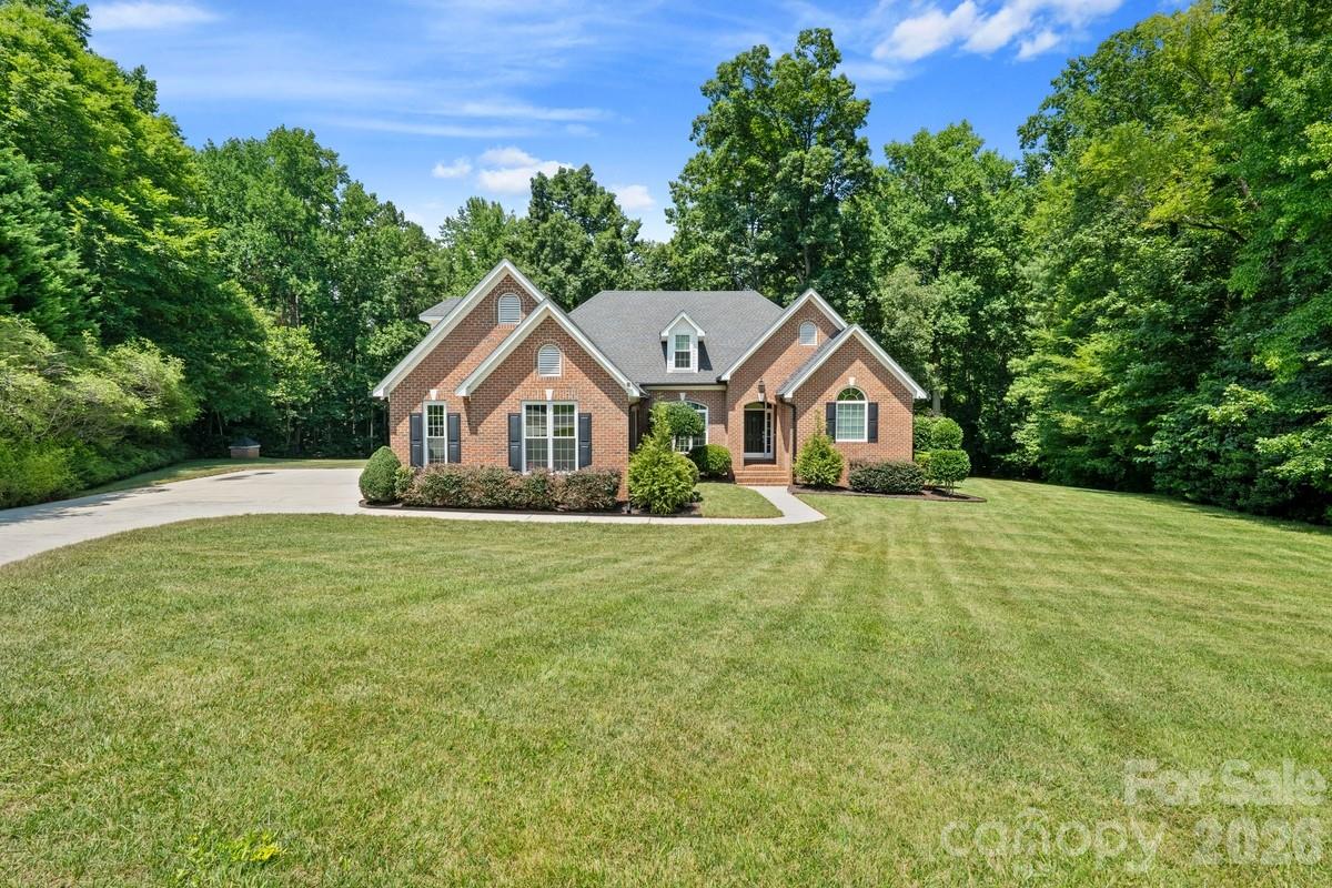 Sought after 1.5 story full brick home,( 3069 sq feet), with 2 car oversized side load garage,( 520 sq feet), 4 bdrm with bonus ,or could be 5 bdrm, 3.5 full bth home.,( recently professionally painted). NO HOA !, Master on main,( with over  25,000 in upgrades), to include, new carpet, fireplace, custom bookshelf,  soaking tub, frameless glass  shower with all the updates, 2 custom built vanities, dual mirrors,  custom flooring,  Also on 1st floor there is 2 guest bdrms, (jack and Jill style with full updated bth). There is an oversized great room,( vaulted ceilings, fireplace), full dining room,( custom archers), breakfast area, all rooms  loaded with crown molding, can lighting,  plenty of windows with natural light.  These rooms all open to the Kitchen that has S/S appliances, gas cooking, under mount dual sinks,  tons and tons of cabinets and built in desk/office space, ( This is a must see area).  Hardwood floors throughout main level, and an extra 1/2bth. 2nd level is a 350 sq. ft. Bonus room, or could be a bedroom, ( perfect for media, rec room, etc), PLUS another guest bedroom with another full updated bth. Home is situated on a 1.69 acre ,Private, wooded, manicured  lot, plenty of room for a pool ,( on a Cul-de-sac). Do not forget to see the 2 story outbuilding/shed has electric, cable, wifi, cast iron wood stove, (perfect MAN-CAVE),  with plenty of room for storage, workshop ,office, or just hanging out. Roof is just 8 years old, recent upgrades include, $12,000 in professionally installed gutters, $16,000 in windows, $20,000 in trex decking. Home is zoned in top of the line public schools and Low South Carolina’s property taxes, ( retired friendly state with benefits). Just minutes away from Lake Wylie , with activities that include boating, fishing, and seasonal celebrations on the water. Also close by is the Carolina Thread Trail with abundance of hiking trails and Anne springs close greenway, ( a 21,000 nature preserve with 40 miles of trails) , also kayaking, paddle board, or fishing available in their ponds and lakes. Just 20 minutes to airport and Uptown city of Charlotte and  shopping and dining are easily accessible in Rivergate, Fort Mill, Tega Cay, and Clover, Belmont, that are all close by.
