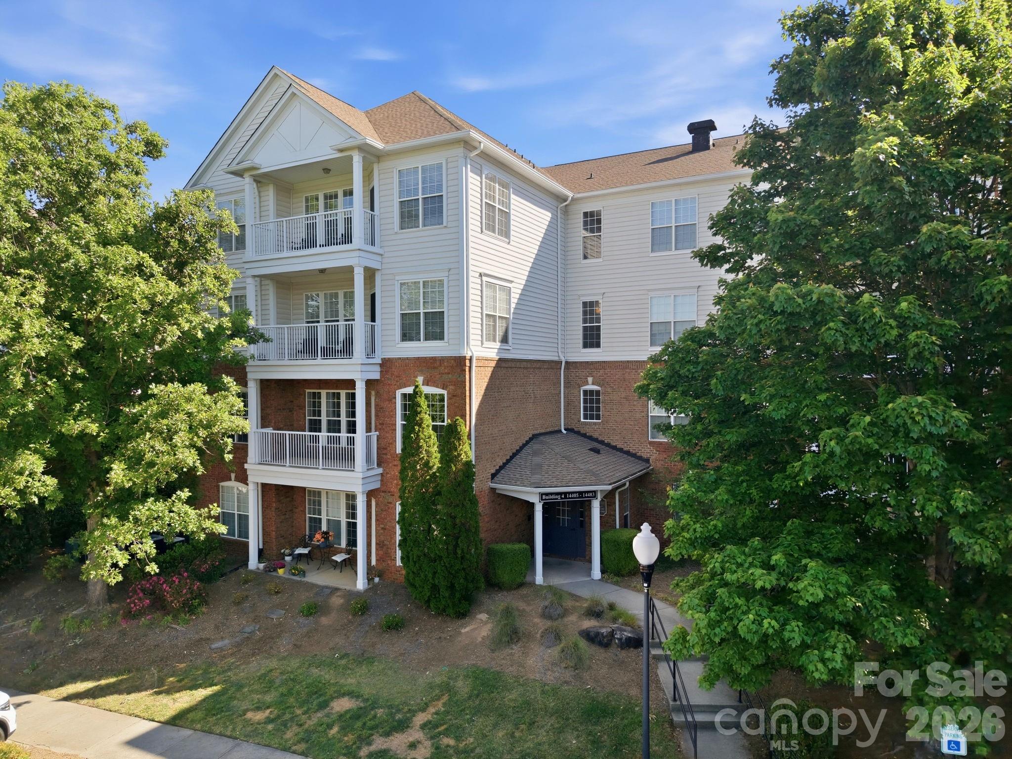 This beautifully maintained second-floor condo offers the perfect blend of comfort, style, and convenience. Featuring three spacious bedrooms and two full bathrooms, this move-in ready home boasts an open floor plan designed for modern living. The inviting living room is highlighted by a cozy gas log fireplace, creating the perfect space to relax or entertain.

The combined dining and kitchen area provides a seamless flow, complemented by elegant wood and tile flooring throughout. Step outside onto your private balcony to enjoy fresh air and peaceful surroundings. The generous primary suite includes a walk-in closet and a well-appointed en-suite bathroom with double vanity sinks.

Additional features include in-unit laundry and ample natural light throughout. Ideally located within walking distance to Ballantyne’s shops, restaurants, and movie theater, this home offers unmatched convenience. Residents also enjoy access to a beautifully landscaped, gated community complete with a clubhouse and sparkling pool.