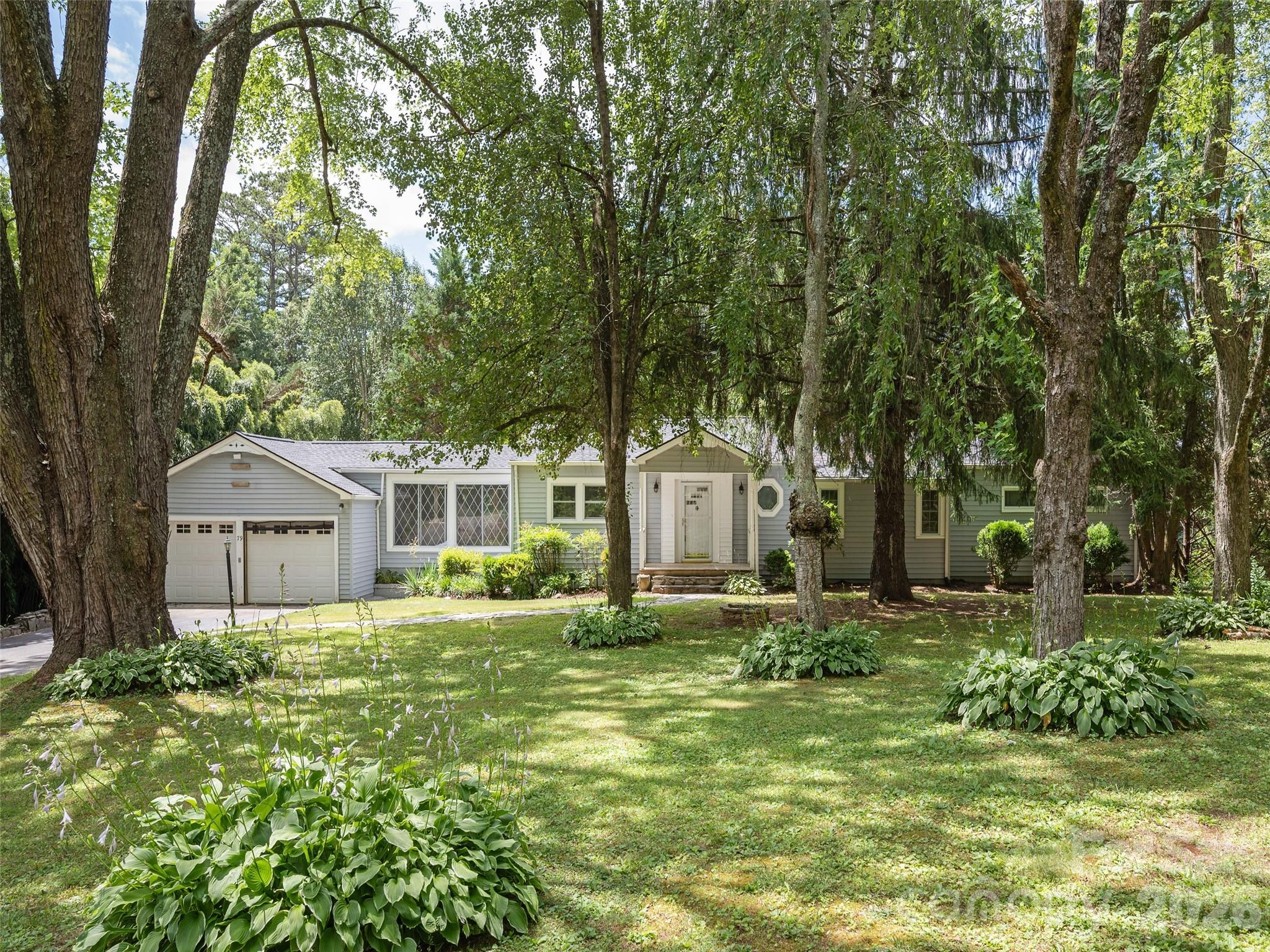 Discover the timeless appeal of this charming 3BR/2BA home with 1,824 sq ft of main-level living in a private, park-like setting surrounded by towering mature trees. The spacious living room features a classic wood-burning fireplace and large windows and built-in corner cabinet. Recent upgrades include a newer roof and covered rear deck. Conveniently located near highly regarded schools, shopping, medical facilities, and other amenities. Additional 1,050 sq ft in partially finished basement offers excellent storage and expansion potential. Full of mid-century character and ready for your personal updates.