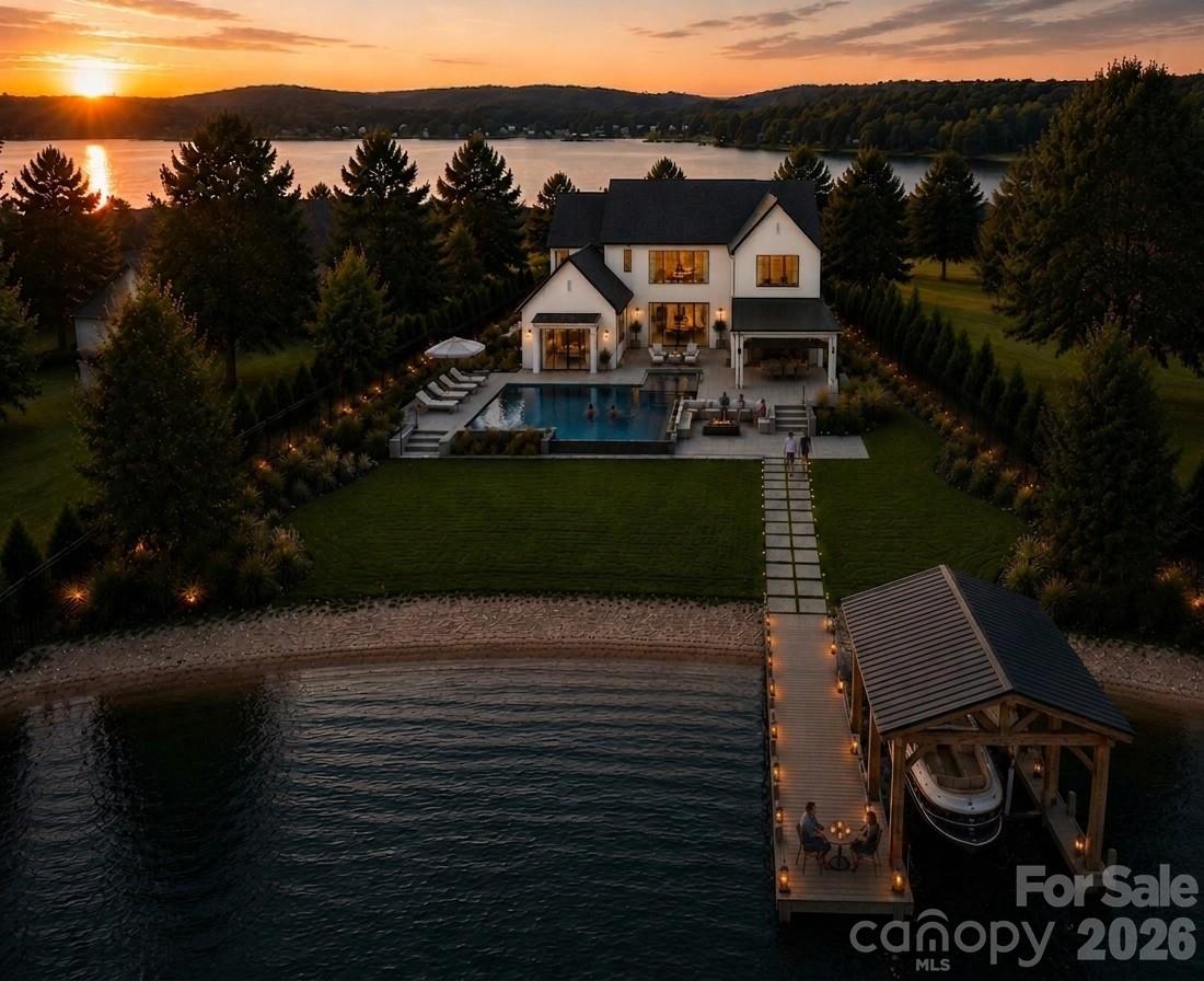 A defining statement of waterfront luxury, 18326 Nantz Road offers a lifestyle reserved for a select few—and one that captures everything Lake Norman living was meant to be. Perfectly positioned on one of Cornelius' most coveted waterfront addresses, this remarkable residence blends timeless California-inspired architecture with warm organic finishes, exceptional craftmanship and a perfect blend of modern and traditional.

One of the home's most extraordinary attributes is its unrivaled location. Nestled along prestigious Nantz Road, a quiet peninsula with virtually no through traffic, this exclusive waterfront setting is surrounded by water, creating an extraordinary sense of privacy while remaining just moments from every convenience. Just across the peninsula, Ramsey Creek Beach offers the nostalgic charm of carefree summer days, just a quick golf cart ride from home.

Inside, every detail has been thoughtfully curated to create an atmosphere of understated luxury. Wide-plank white oak flooring, soaring ceilings accented with architectural white oak beams, oversized black windows, custom millwork, designer lighting, and carefully layered natural textures provide a timeless backdrop throughout.

Every room reveals a new architectural moment. Handcrafted zellige tile, custom designer cutout details, warm white oak, and richly layered natural textures give the home a sense of authenticity and soul. A striking glass pivot front door welcomes guests with dramatic elegance, while the floating glass staircase serves as a sculptural centerpiece, blurring the line between architecture and art. From bespoke millwork to thoughtfully curated designer finishes, every turn reveals another unexpected detail, creating a home that feels both timeless and unforgettable.

At the heart of the home, the chef's kitchen is both a showpiece and a culinary masterpiece, featuring custom white oak and painted cabinetry, an oversized Taj Mahal quartzite island, a sculptural plaster range hood, and a premium Thermador appliance suite anchored by a 48-inch dual-fuel range and panel-ready refrigeration. Hidden just beyond, the fully equipped scullery offers additional prep space, a farmhouse sink, dishwasher, wine storage, custom cabinetry, and a built-in workspace—allowing effortless entertaining while keeping the main kitchen beautifully organized.

The main-level primary suite is a private sanctuary overlooking the water, complete with a spa-inspired bath featuring custom white oak cabinetry, designer stone selections, a freestanding soaking tub, an oversized walk-in shower, and carefully curated luxury fixtures. Every secondary bedroom enjoys its own beautifully appointed en-suite bath, while expansive living and entertaining spaces invite family and friends to gather in effortless comfort. A private guest suite above the attached three-car garage provides exceptional accommodations for extended family, overnight guests, an au pair, or a sophisticated executive office, offering privacy while remaining seamlessly connected to the home.

Step outside and discover an outdoor experience that rivals the finest private resorts. The spectacular pool and spa serve as the centerpiece of an extraordinary backyard designed for unforgettable entertaining, with expansive covered terraces, generous lounging areas, and seamless indoor-outdoor living.

A brand-new deep-water dock provides immediate access to everything Lake Norman has to offer—from boating, wake surfing, paddleboarding, and fishing to waterfront dining and sunset cruises. Spend the morning exploring the lake, anchor at Ramsey Creek Beach for the afternoon, then return home to relax beside your resort-style pool as the evening settles over the water.

From its extraordinary waterfront setting to its unforgettable architectural moments, this is a once-in-a-generation opportunity to own one of Lake Norman's signature waterfront estates.