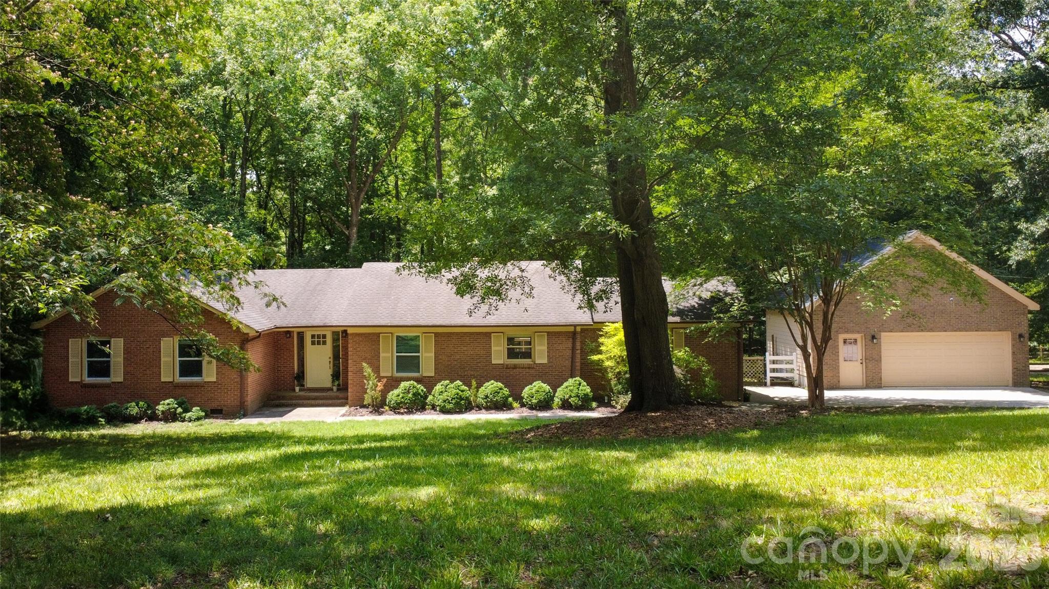 Discover the perfect blend of country charm and modern convenience in this all-brick ranch nestled on 1.4 acres in a sought-after equestrian community. The open-concept floor plan offers effortless living, featuring laminate wood flooring throughout the kitchen and living area, creating a warm and inviting space for entertaining. The spacious kitchen flows seamlessly into the great room and includes a convenient butler's pantry area for added storage and prep space.

A versatile flex room just off the mudroom is equipped with its own split-system HVAC, making it ideal for a home office, gym, workshop, or hobby space. Step outside to the expansive covered rear deck, where you'll enjoy relaxing evenings overlooking the private fenced backyard and hot tub.

Car enthusiasts and hobbyists will appreciate the oversized detached two-car garage with plenty of room for storage and projects. Residents of this picturesque equestrian neighborhood enjoy walking and riding trails, offering an exceptional lifestyle surrounded by nature. All of this is just minutes from Ballantyne and conveniently located near the RedStone Shopping Center, providing easy access to shopping, dining, and everyday conveniences.
