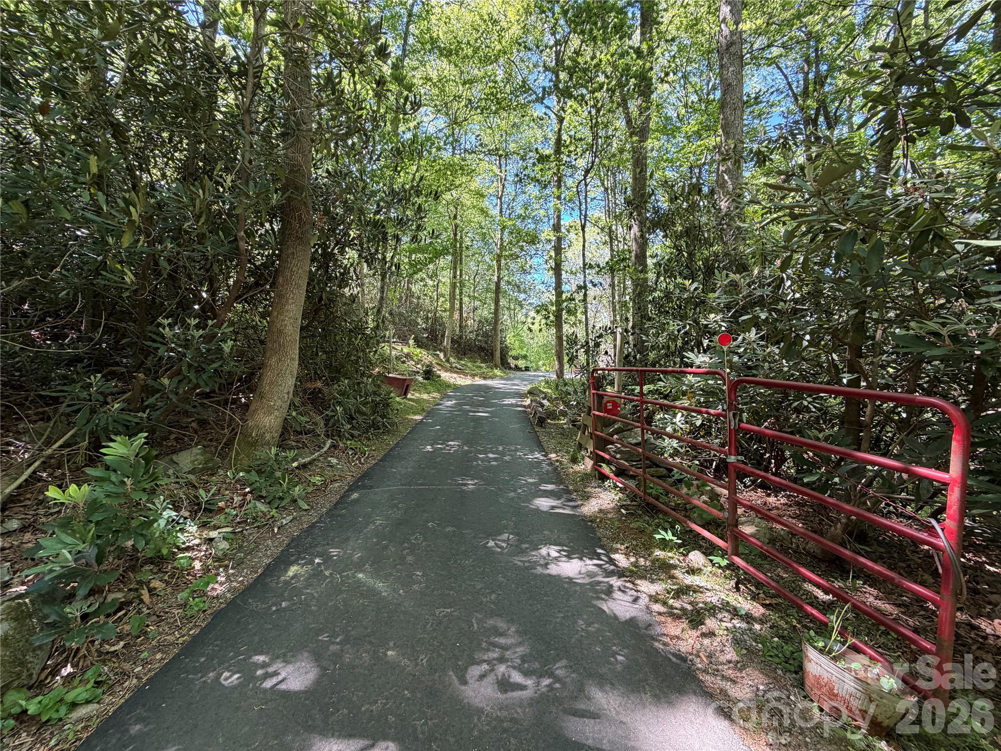 Private 1.49 acre homesite opportunity in Fairview. Previous home was lost to fire and the property has since been cleared, offering a clean slate for new construction. Newly paved driveway leads to a prepared homesite area with wooded surroundings and mountain setting. Convenient access while still offering privacy and natural beauty. Existing well head is beneath rock pile shown in photos. Great opportunity for primary residence, mountain getaway, or investment property in desirable Fairview location.