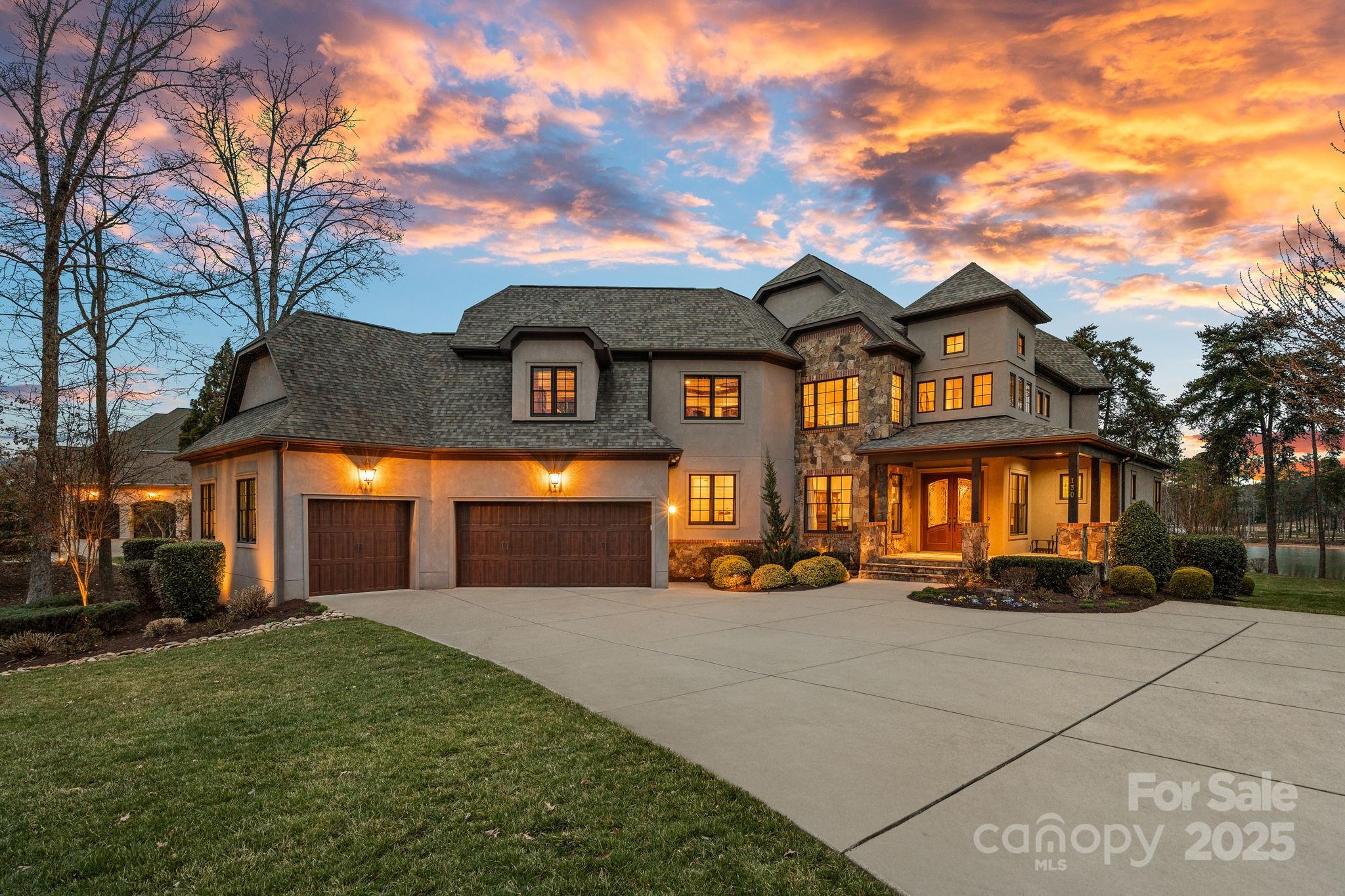 Exquisite waterfront living in The Point, offering breathtaking lake and sunset views. This 4-bedroom, 5.5-bathroom home, built in 2015, spans 5,744 sq. ft. and sits on 250+ feet of shoreline with a rare private beach. The private dock on a deep-water cove provides easy main channel access for enjoying Lake Norman.

With three levels of well-designed space, including a second-level bonus room, this home offers endless possibilities. A main-level flex room with a full bath is ideal as a guest suite or office. Expansive windows fill the home with natural light and stunning waterfront views. The lower level features a see-through fireplace, recreational space, bar, wine storage, and drop zone with full bath.

The outdoor space is impressive, with a screened-in porch, fire pit, and a spacious yard with room for a pool, all perfectly positioned for gorgeous sunset views.

Just a short walk from The Point’s world-class amenities, this home offers the best of luxury lakefront living.