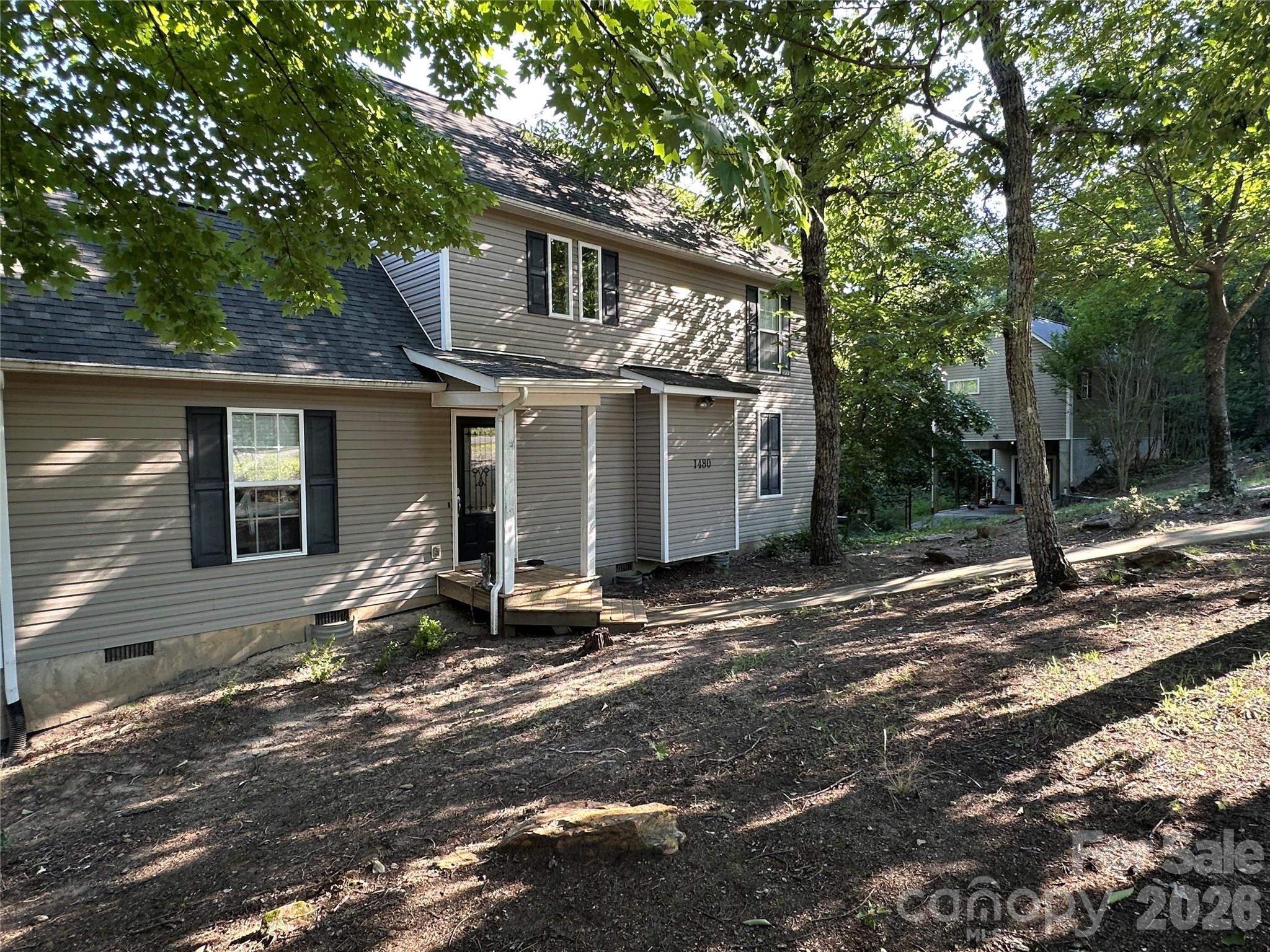 The main home offers 3 bedrooms and 2 bathrooms, plus a separate living space above the detached garage with 1 bedroom, 1 bathroom, and a kitchenette. Tucked away in a private spot, it delivers a vacation-like feel every day and comes with a wooded lot next door. A cozy private deck is perfect for sipping your morning coffee or firing up the grill for a laid-back evening.