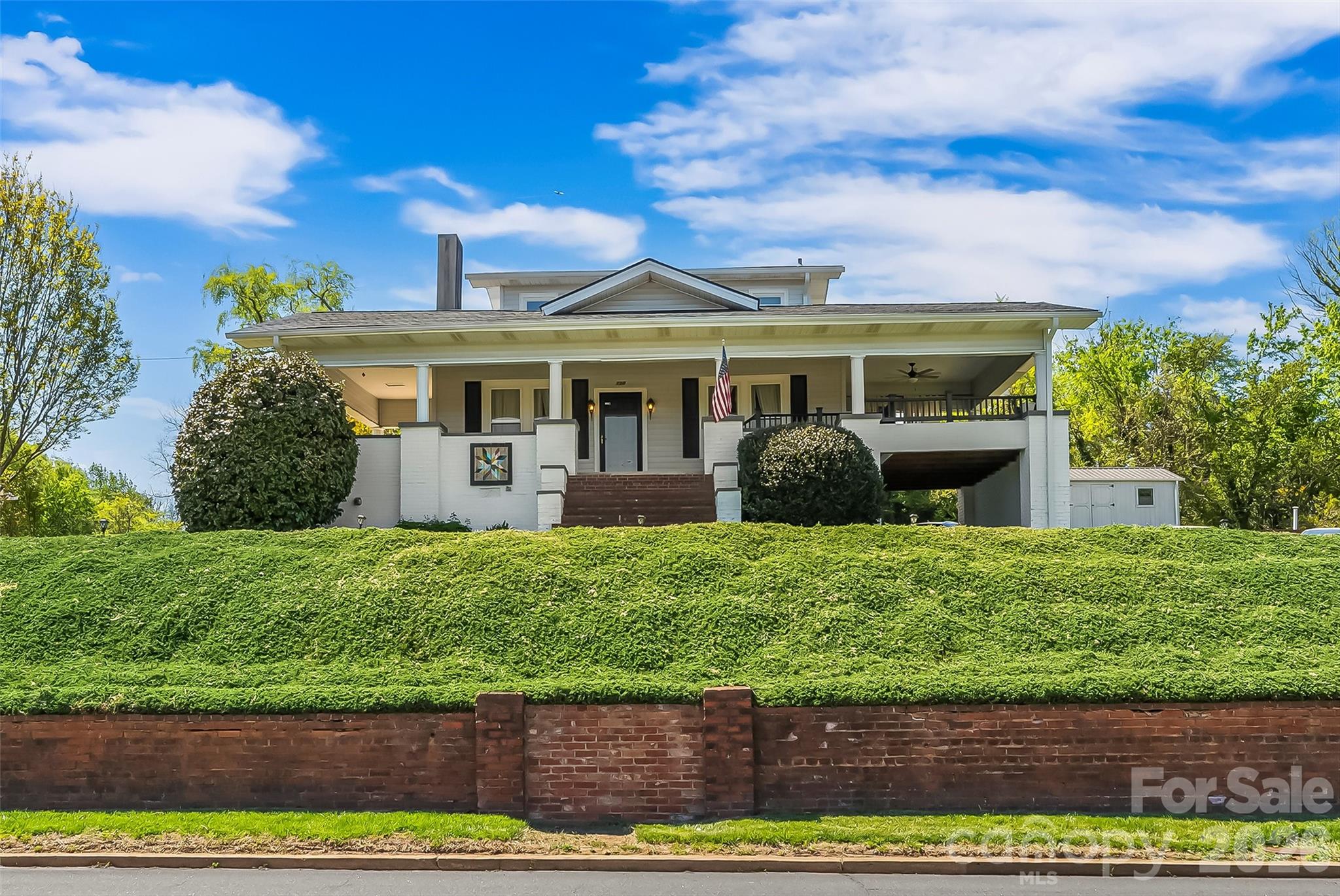 Charming home located just off historic West Union Street, offering easy access to sidewalks that lead you anywhere downtown Morganton has to offer! This inviting property features a huge wraparound porch perfect for relaxing or entertaining with a built in gas grill. Inside, you’ll find high ceilings, spacious rooms, and classic character throughout. The main level includes a primary bedroom and bath, along with a convenient laundry area. Beautiful hardwoods and luxury plank vinyl throughout. Upstairs offers two additional bedrooms filled with natural light and scenic views. The basement provides excellent space for storage, a workshop, or canning. Outside, enjoy a level backyard with endless possibilities for gardening or outdoor living, plus two outbuildings with power. Ideal for hobbies or additional storage. New roof in 2025. A well cared for home full of charm in an unbeatable location.