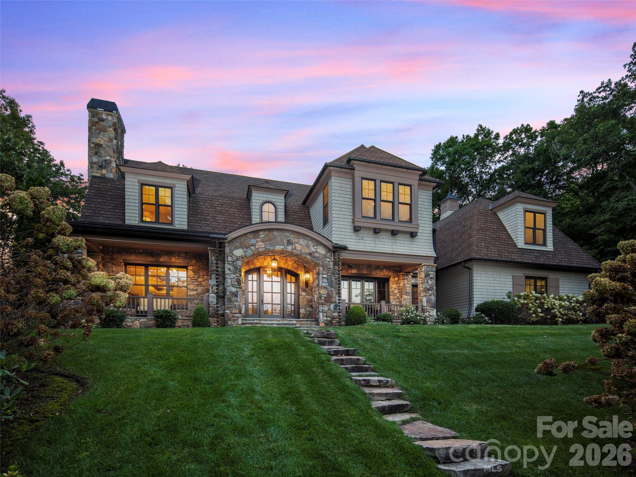 Nestled within the prestigious Cliffs at Walnut Cove, 1946 White Tree Trail is a masterpiece of design and privacy, situated on a sprawling estate created from two combined lots - with an additional lot available. Built by the renowned Glennwood Custom Builders, this residence offers an ultra-private sanctuary that remains just minutes away from the vibrant club village and the world-class Jack Nicklaus Signature golf course, which is celebrated for its national park-like setting and dramatic elevation changes. The exterior of the home is a horticultural marvel, featuring massive gardens and hundreds of curated plantings that frame the property in year-round color and texture. The interior showcases a thoughtful, sophisticated layout highlighted by hand-scraped flooring, elegant barrel ceilings, and unique architectural surprises like a hidden room and a dedicated private guest entrance. At the heart of the home, the gourmet kitchen with thee ovens, two dishwashers flows into the family room that features a massive wall of accordion doors that peel back to integrate the indoors with a sprawling screened porch equipped with Phantom screens and a full outdoor kitchen, making it an unrivaled setting for both quiet relaxation and grand-scale entertaining.

Living in this gated community provides access to a wealth of world-class amenities designed for an active and luxurious lifestyle. The central Club Village serves as the social heart of the neighborhood, home to the Tavern at Walnut Cove, an Old World-inspired venue offering fine dining, a wine room with sommelier-curated selections, and a lively bar for gathering with neighbors. Residents enjoy a comprehensive wellness program centered around an 18,000-square-foot Wellness Center, which includes state-of-the-art fitness equipment, indoor and outdoor swimming pools, and a full-service spa offering massage and steam rooms. For those who love the outdoors, the community abuts the Pisgah National Forest, providing miles of private hiking and nature trails right at your doorstep. The racquet sports complex features Har-Tru tennis courts, while the unique Creekside Farm "agrihood" offers fresh organic produce through a community-supported agriculture program.