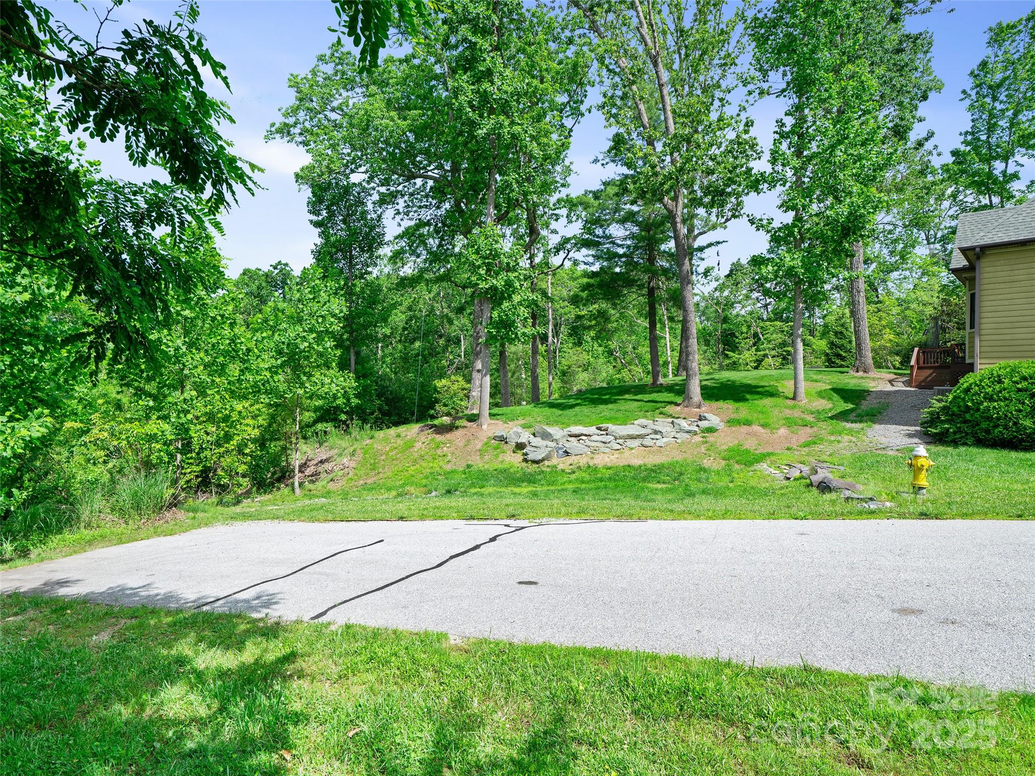Rare opportunity to own +/- 1.91 acres of prime vacant land on Millbrae Loop in one of Hendersonville’s most desirable communities - Carriage Park. This homesite is ideal for creating a private estate or developing multiple residences. With flat to gently sloping terrain and mature trees, the property is perfect for those seeking privacy, beauty, and investment potential. Located within a 24 hour manned gated community with potential access to underground utilities, city water, city sewer (buyer to verify) and paved roads. Easy to access and easy to show with a nice trail leading throughout the property. Enjoy top-tier amenities—clubhouse, indoor pool, tennis, and pickleball—all just minutes from vibrant downtown Hendersonville. This property is also available as a 3.74 parcel, see MLS 4261475 for more information. Contact the listing agent and schedule your private showing today!
