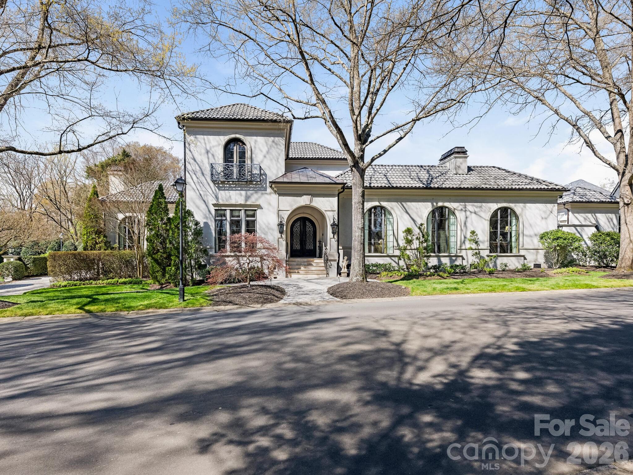 One-of-a-kind exquisite hard coat stucco home with gorgeous green tile roof in gated community of Seven Eagles. A stunning front entrance welcomes you with a covered copper roof and custom lanterns setting the tone for this fine craftsmanship throughout. Hand forged iron railings add timeless character and detail. Inside, an elegant and sophisticated formal living room features a striking two sided fireplace and flows seamlessly into a handsome, well appointed study with a coffered ceiling. Spectacular additional high ceilings including groin, dome and various other styles. Expansive windows, French doors and arched doorways fill the home with natural light and architectural presence. Heavy moldings and deep baseboards. Travertine, marble and granite heated flooring. The chef's kitchen features a generous island with seating and open to a warm and inviting family room with art niches flanking gas fireplace plus breakfast area. Viking refrigerator, Miele gas cooktop, 2 Miele wall ovens, warming drawer and double Miele dishwashers. A butler's pantry with sink, ice maker, wine cooler and beverage refrigerator enhances the homes hosting appeal. Nook perfect for piano. The spacious primary suite on the main level is a true sanctuary, complete with double sided fireplace that can also be enjoyed in the primary bath with soaking tub, shower with 2 entrances and walk-in closet. Doors to enclosed courtyard with salt water pool and spa. Versatile exercise room with cork flooring and full bath including steam shower. Outdoor grill, beverage refrigerator plus ambient linear flame fire pit. Laundry room with sink and convenient dog shower door leading to back yard. Sweeping marble staircase leads to loft and 2 private ensuite bedrooms with walk-in closets. 2 car side load garage with storage room. Serene neighborhood park adjacent to property. Encapsulated crawl space, whole house water softener, tankless water heater, surround sound and security system. Minutes to retail, restaurants and South Park Mall. Easy access to major highways and the airport. So many more details.