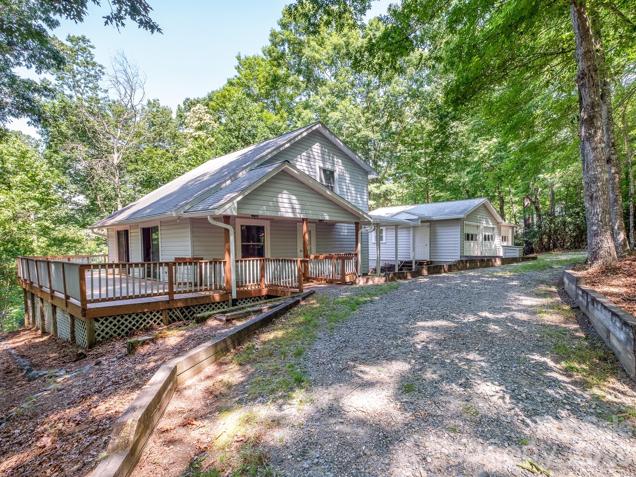 Tucked away in the peaceful Hidden Valley subdivision of Pisgah Forest, this 3-bedroom, 2-bath home offers the perfect blend of privacy, potential, and an unbeatable location. Situated on a sloping, wooded double lot, the property provides a serene natural setting just minutes from downtown Brevard, Pisgah National Forest, and DuPont State Recreational Forest. The home features a spacious 3-car garage, expansive decks ideal for entertaining or relaxing among the trees, and a fenced backyard for pets, play, or gardening. Inside, you'll find a solid floor plan ready for your personal updates and vision. Whether you're looking for a full-time residence, mountain retreat, or investment opportunity, this home offers a rare chance to create your own space in one of Transylvania County's most desirable areas. Enjoy the tranquility of mountain living with convenient access to hiking, biking, waterfalls, shopping, dining, and all the outdoor recreation that makes Pisgah Forest and Brevard such sought-after destinations. Bring your ideas and unlock the potential of this Hidden Valley gem!