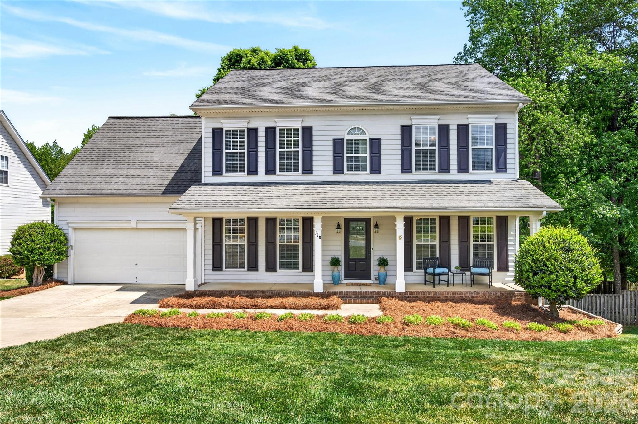 Welcome to this beautifully updated home in the highly desirable Mooresville Graded School District, with a great mix of modern style and comfortable living. Ideally located just minutes from I-77, enjoy an easy commute to Charlotte along with convenient access to shopping and dining. Nestled at the back of a quiet neighborhood and backing up to a greenway, this move-in ready home is immaculate. A welcoming front porch invites you to relax—perfect for rocking chairs and morning coffee. Inside, the open yet defined floor plan features both formal and open, flexible living spaces. The main level showcases updated LVP flooring, fresh paint, and a beautifully renovated kitchen with painted oak cabinetry, quartz countertops, and stainless steel appliances. Upstairs, retreat to four spacious bedrooms, including a shared hall bath and a dedicated laundry room with tiled floors and additional storage. The primary suite upstairs features a walk-in closet, and an updated ensuite bathroom with garden tub and separate tiled shower. Walk-out attic storage provides excellent space for seasonal decor and travel gear. Huge basement storage area with exterior access that could be used as a workshop or recreation room! Outdoor living is equally impressive, with fresh pine straw, a lush lawn, and a fully fenced backyard with multiple gates and greenway access. Enjoy the expansive deck with a retractable awning, overlooking the peaceful natural setting. Neat as a new pin!
