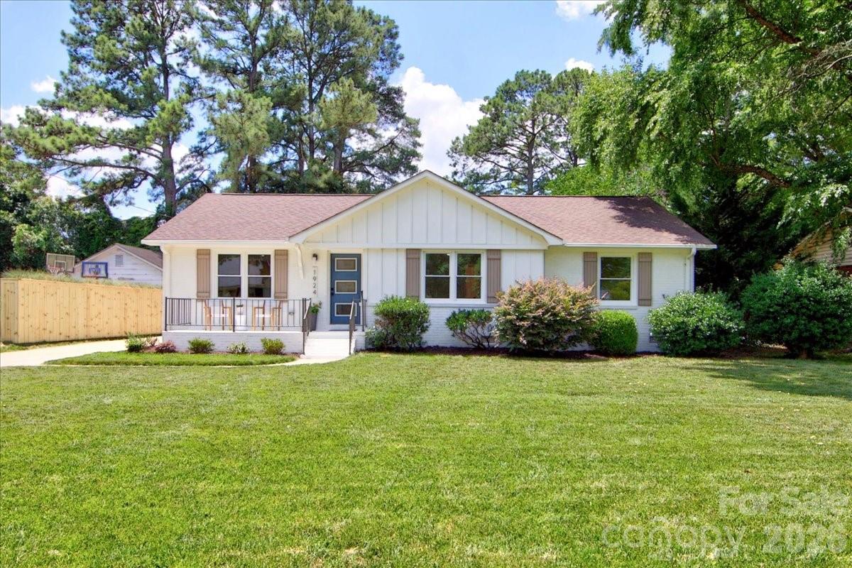 Hip, cool, this fully renovated mid-century modern showstopper delivers the ultimate indoor-outdoor entertaining lifestyle in the heart of Charlotte, NC. Integrating authentic architectural bones with  contemporary updates, this property is a masterclass in effortless, high-design living. Light hardwood floors, open great room, kitchen and dining. Entertain in style with the built in wine fridge bar area. Kitchen features a large center island, 42 inch cabinets and stainless appliances. The primary suite has two generous closets and a large en suite bathroom with a quartz double vanity and large shower with beautiful tile. Hall bathroom includes a tub and architectural tile. A  laundry/mudroom leads to the backyard which includes a sleek, carport structure that honors original mid-century lines while offering plenty of sheltered parking and entertaining space. A self-contained, matching detached guest house serves as a hip private suite for visitors, a dedicated home office, or an upscale pool-house vibe. So many possible uses for this space overlooking the dining patio. A private backyard is fenced with garden area and storage room behind the guest house. Close to Midwood and Central Ave restaurants, bars, shops and more.