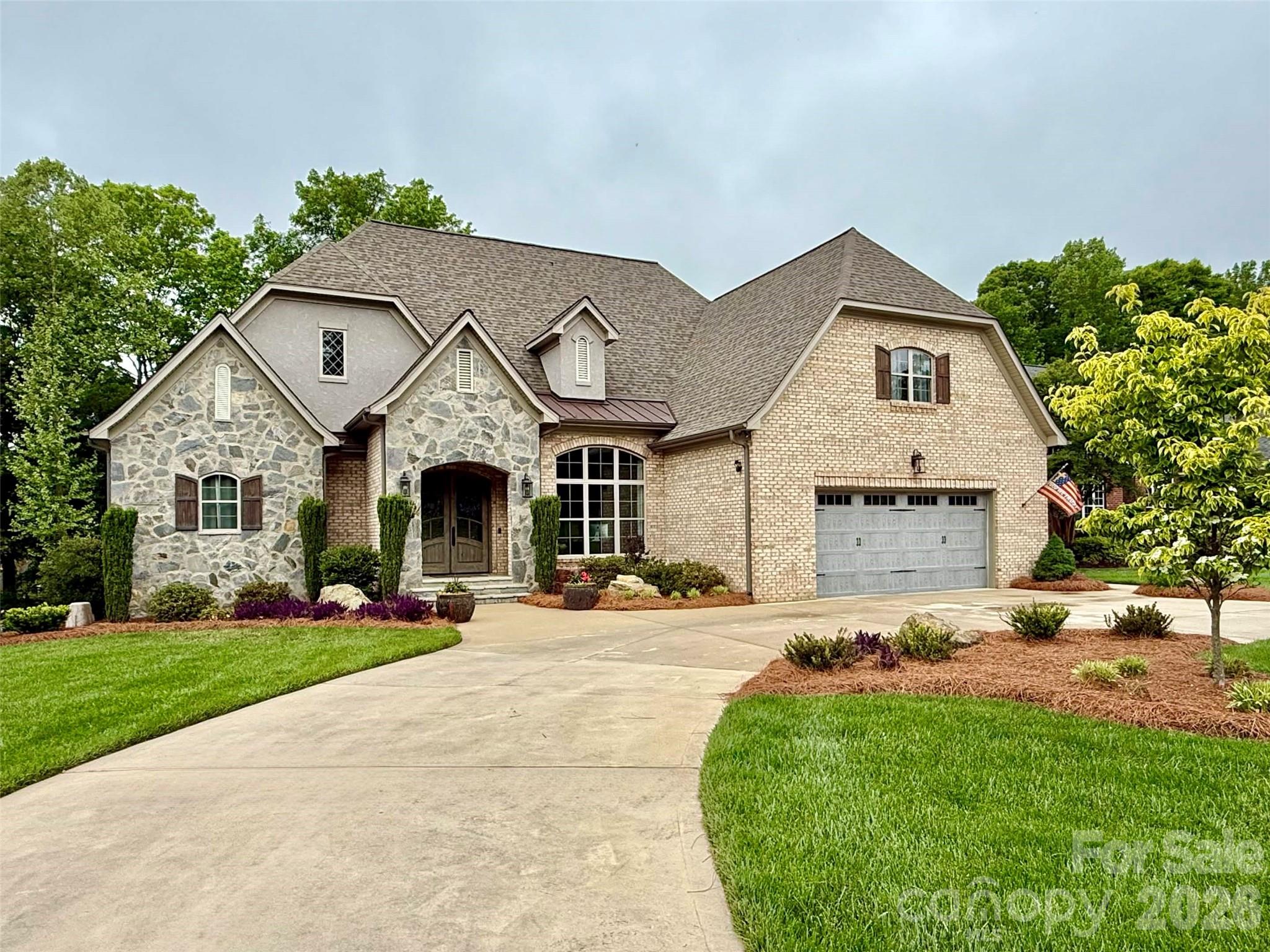 An Architectural Triumph of Luxury & Comfort in Gated Cramer Mountain. 

Arrive via the stately circular drive to find a home where every detail has been meticulously curated. This custom-built estate offers an unparalleled presence, framed by designer professional landscaping. Step through the grand entrance to discover a masterpiece of "Old World" quality and modern open-concept design, highlighted by a great room with soaring exposed beams and bespoke custom finishes.

The true heart of the home is the executive chef’s kitchen, a culinary sanctuary featuring natural stone countertops, a hammered farmhouse sink, and a high-performance gas range with double ovens. Entertain with ease using the integrated wet bar and wine fridge, while under-cabinet lighting illuminates the artisan stone backsplash. The main level is thoughtfully designed for longevity, offering both a magnificent primary suite and a full secondary guest suite, plus a sophisticated dedicated office.

Modern infrastructure provides total peace of mind, including a whole-house generator, tankless water heater, dual HVAC systems, and two separate laundry areas. Outdoor living is equally refined, featuring a peaceful screened-in porch and a built-in outdoor gas grill station. Located within a premier gated golf course community, this estate offers a lifestyle of quiet luxury with optional club access to world-class golf, tennis, and swimming.