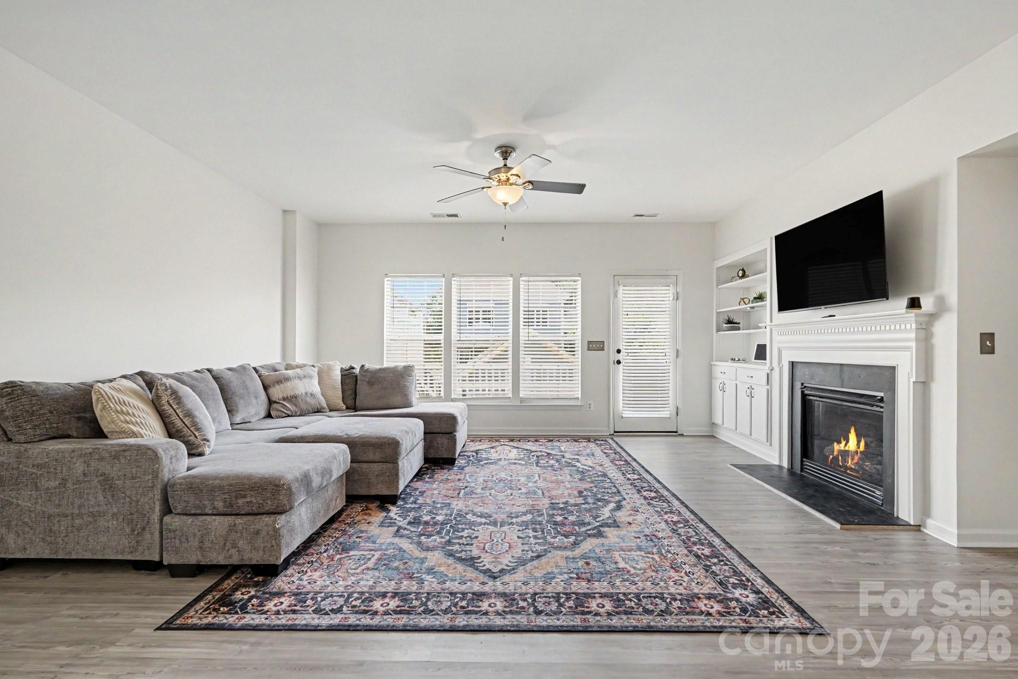 Enjoy the convenience of living in one of South Charlotte's most sought-after locations, just steps from Blakeney's vibrant shopping, dining, and entertainment options. With grocery stores, restaurants, boutiques, and seasonal events all within walking distance, this location offers an exceptional lifestyle.

This spacious three-story townhome features luxury vinyl plank flooring throughout and a flexible lower-level bedroom with a full bath, ideal for guests, a home office, or a private retreat. The main living level is bright and inviting, offering abundant natural light, a cozy gas fireplace, and an open layout that flows seamlessly to the recently updated rear deck with low-maintenance composite decking.

The kitchen offers generous cabinet and counter space, black granite countertops, appliances, a stylish subway tile backsplash, and room for either a center island or casual dining area. The kitchen cabinets have been freshly painted, giving the space a clean and updated feel.

Upstairs, you'll find two generously sized bedroom suites, each with access to a full bathroom, creating privacy and comfort for homeowners and guests alike. A conveniently located laundry closet completes the upper level.

The current owners have made numerous improvements, including a professionally refinished garage floor, fresh interior paint and wall touch-ups, new blinds throughout, and recently installed refrigerator, washer, and dryer that convey with the home with the right offer. 

Enjoy added peace of mind with several recent updates, including a 2022 roof (maintained by the HOA along with the home's exterior), a water heater replaced in May 2021, and 2025 washer, dryer, and refrigerator. The HVAC system has a manufacturing date of 2015–2016.

With its functional floor plan, thoughtful updates, neighborhood pool, and unbeatable walkable location, this move-in-ready townhome makes it easy to leave the car behind and enjoy everything Blakeney has to offer!
