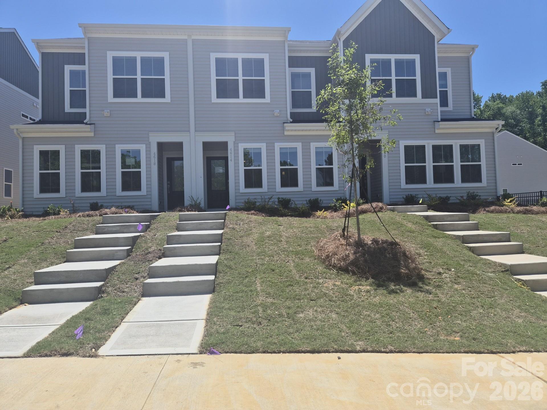 Discover the charm of this boutique townhome community built by Mungo Homes, a leader in quality craftsmanship & luxury design. This beautiful north-facing two-story townhome features 3 bedrooms, 2.5 baths, & a rear-entry one-car garage, double size driveway, offering an open-concept layout with stylish upgrades finishes throughout. The main floor boasts luxury vinyl plank flooring, creating a seamless flow through the bright & airy living spaces. The chef’s kitchen is a standout, featuring a large sitting island w/ Quartz countertop, Stone Gray cabinetry, tile backsplash, pendant lighting, & SS electric appliances! Upstairs, the spacious primary suite impresses w/ a 10' boxed ceiling, generous walk-in closet, & a en suite bath w/ a quartz-topped dual vanity & a tiled walk-in shower. Two additional bedrooms, a full bath, & a convenient laundry closet complete the second level. Located just minutes from Uptown Charlotte, the airport, & shopping, Lakeview Village offers the perfect blend of style, comfort, & convenience. Ask about Move-in package & Financing Promotions! 2025 Parade of Homes GOLD Winner!  Representative Photos Only - Home is under construction with completion estimated for May.