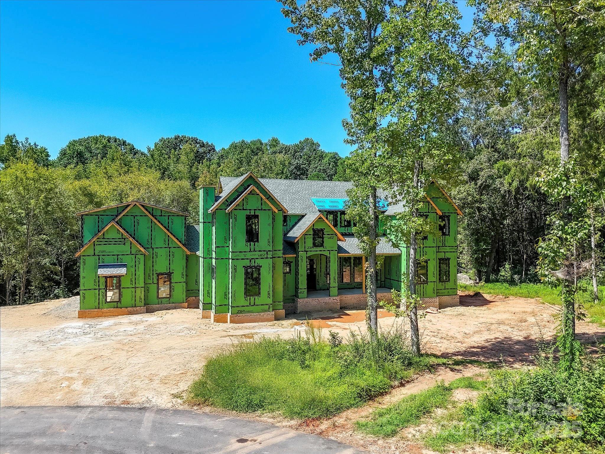 Stunning new construction in the exclusive Cachet of Davidson on a private 2.16-acre cul-de-sac lot! This 6BR, 5BA, 2 half-bath retreat blends elegance with modern convenience, featuring soaring ceilings, lavish finishes & full home automation. Gourmet chef’s kitchen boasts top-of-the-line appliances, dual dishwashers, sprawling island & built-in espresso machine. Gather in one of 3 fireplaces — Great Room, Study, or Family Room. Main-level vaulted primary suite offers spa-like bath & dual walk-in closets. Walk-out basement includes 2nd kitchen/bar, rec space & guest suite. Private guest quarters above 3-car garage include full kitchen, living room, bedroom, bath & laundry. Outdoors enjoy professional landscaping & in-ground irrigation. Minutes from Downtown Davidson yet tucked just inside Cabarrus Co for added benefits — a perfect blend of luxury, privacy & convenience!