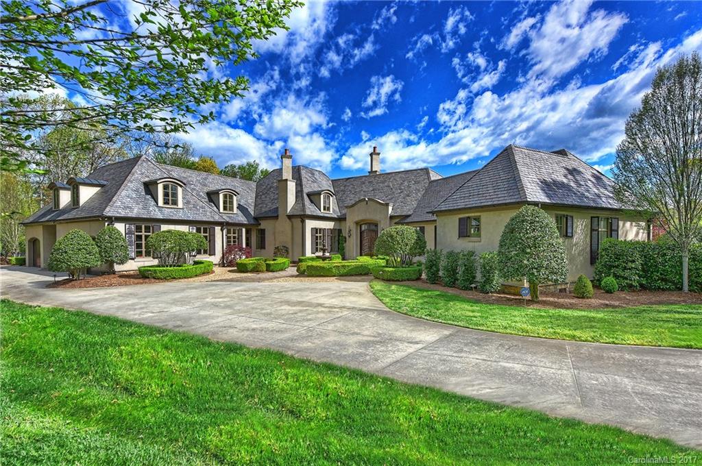 Unique custom home on ALMOST 4 ACRES of privacy, just 5 minutes from SouthPark. Open floor plan. Incredible views from every room of the lake and pool, surrounded by woods. The covered porch has a stone fireplace and connects to the tremendous terrace with expansive views. Cook's kitchen has a keeping room and opens to the great room- all overlooking the grounds. Mahogany paneled grand den. Luxurious wet bar. Rustic wine cellar. Rec & exercise room. A true master retreat. Breath-taking property!