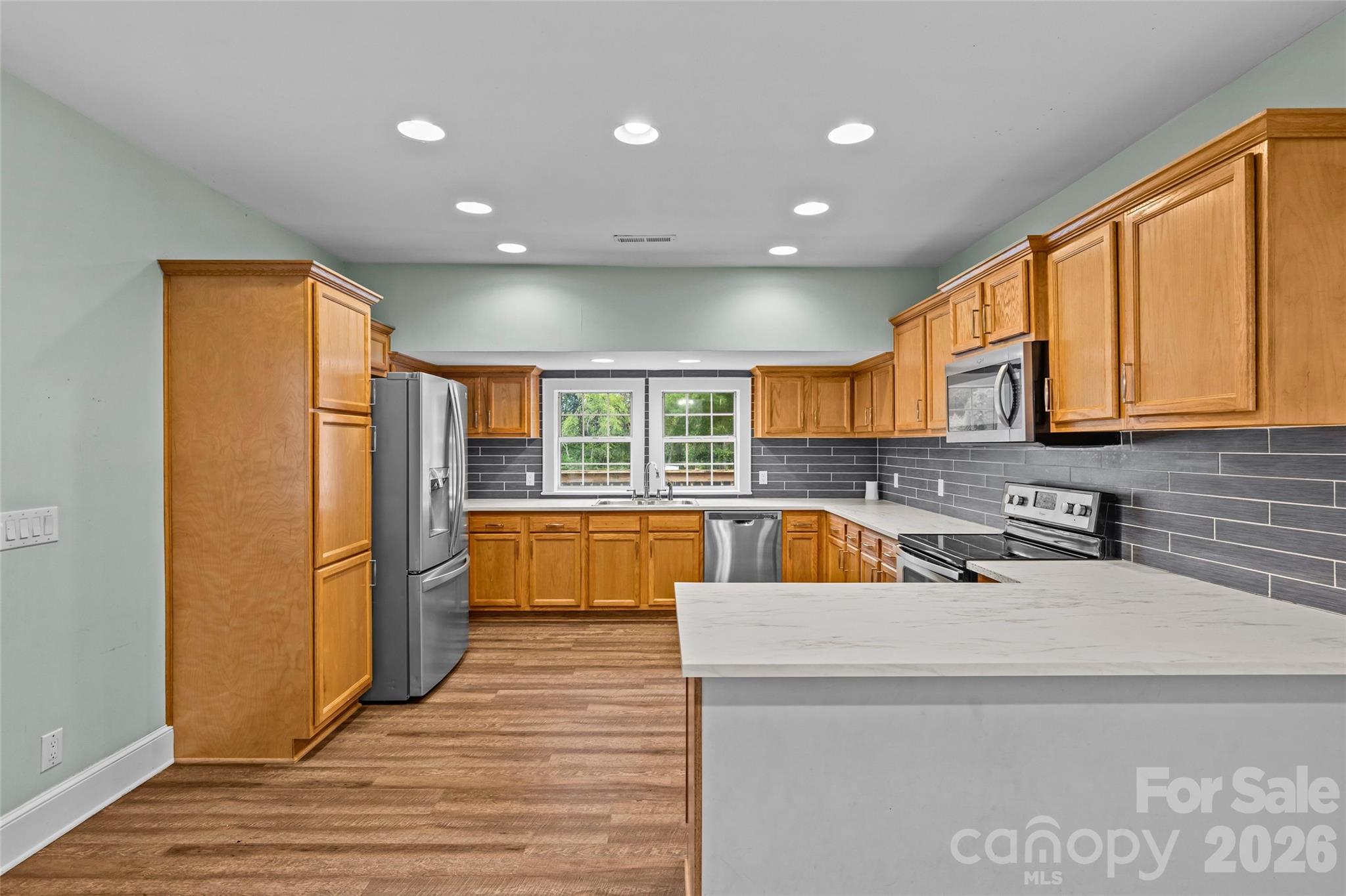 Discover the charm and privacy of this farmhouse cottage nestled on a sprawling 0.8-acre lot in highly desirable Matthews! This 2-bedroom, 2-bath home offers 1,508 sq ft of character-rich living space with NO HOA. Enjoy a spacious kitchen with stainless steel appliances, modern flooring, and a beautiful tray ceiling in the second bedroom. Relax on the inviting front porch or entertain on the generous rear deck. The large, partially fenced lot provides ample room for pets, play, or future additions. Ideally located close to shopping, dining, and good schools, this is your rare opportunity to enjoy land and freedom just minutes from it all!