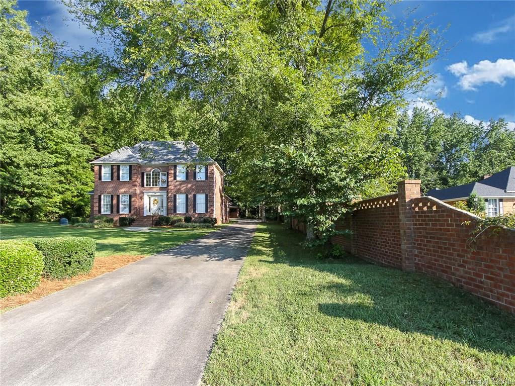 Stately all brick two story home has 4 bedrooms, (two up and two down) master on the main floor,  bedroom with en-suite on second floor. Large open kitchen with breakfast nook. Family room beautiful built ins, fireplace, wet bar and French doors leading to an open outdoor patio. Formal dining room with wainscoting. Main floor has hardwoods and beautiful crown molding. Detached 2 car carport. Great yard across from golf course. Seller offering Home Warranty.