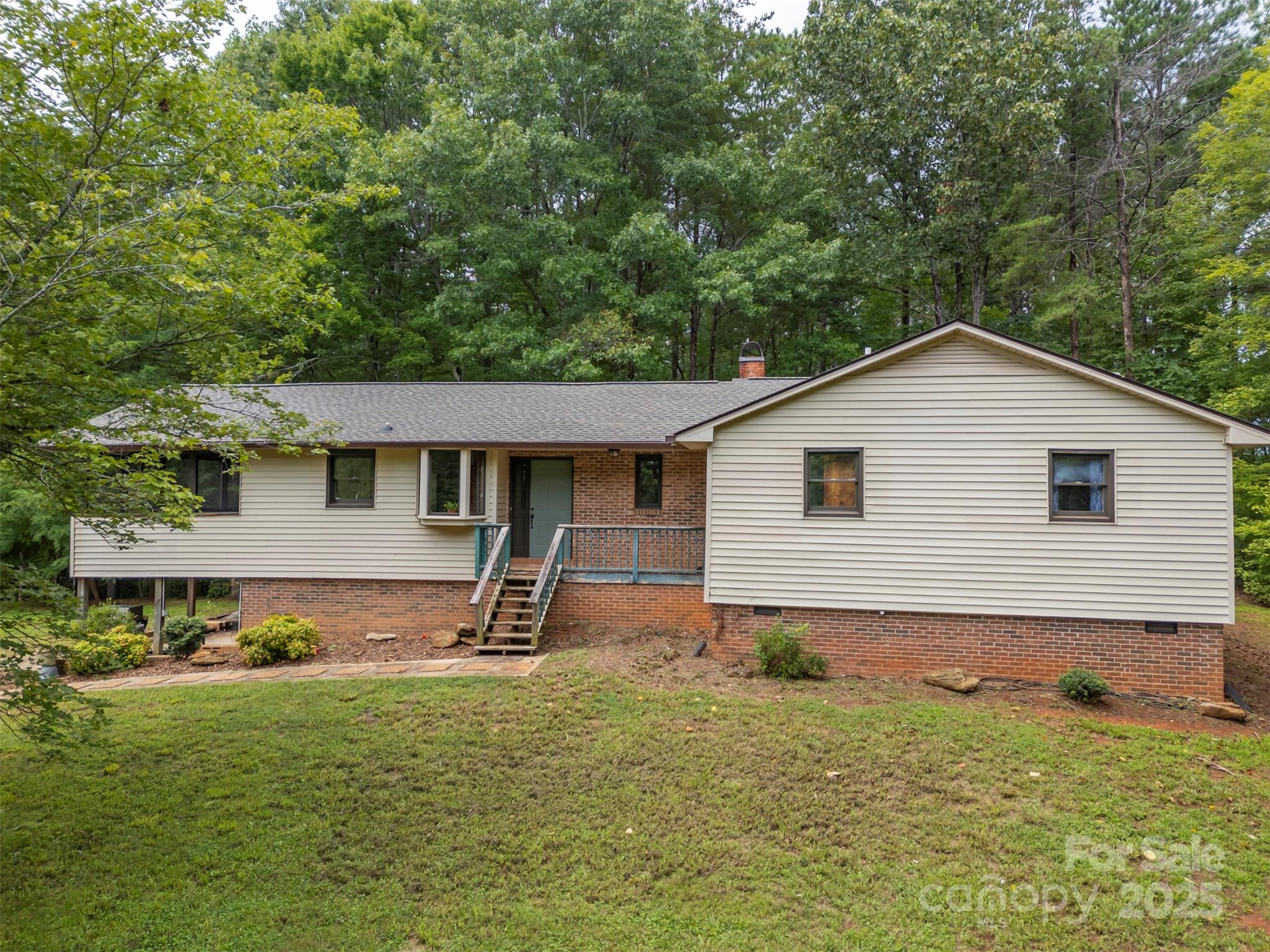 Discover serene country living in this 3 bedroom, 3 bath home sits on almost 4 acres with hardwood trees for upmost privacy. Step into a spacious primary bedroom with ensuite bathroom, designed for luxury and comfort. Entertain guest in the expansive living room and adjacent dining room. A side screened in porch is the perfect spot for morning coffee.