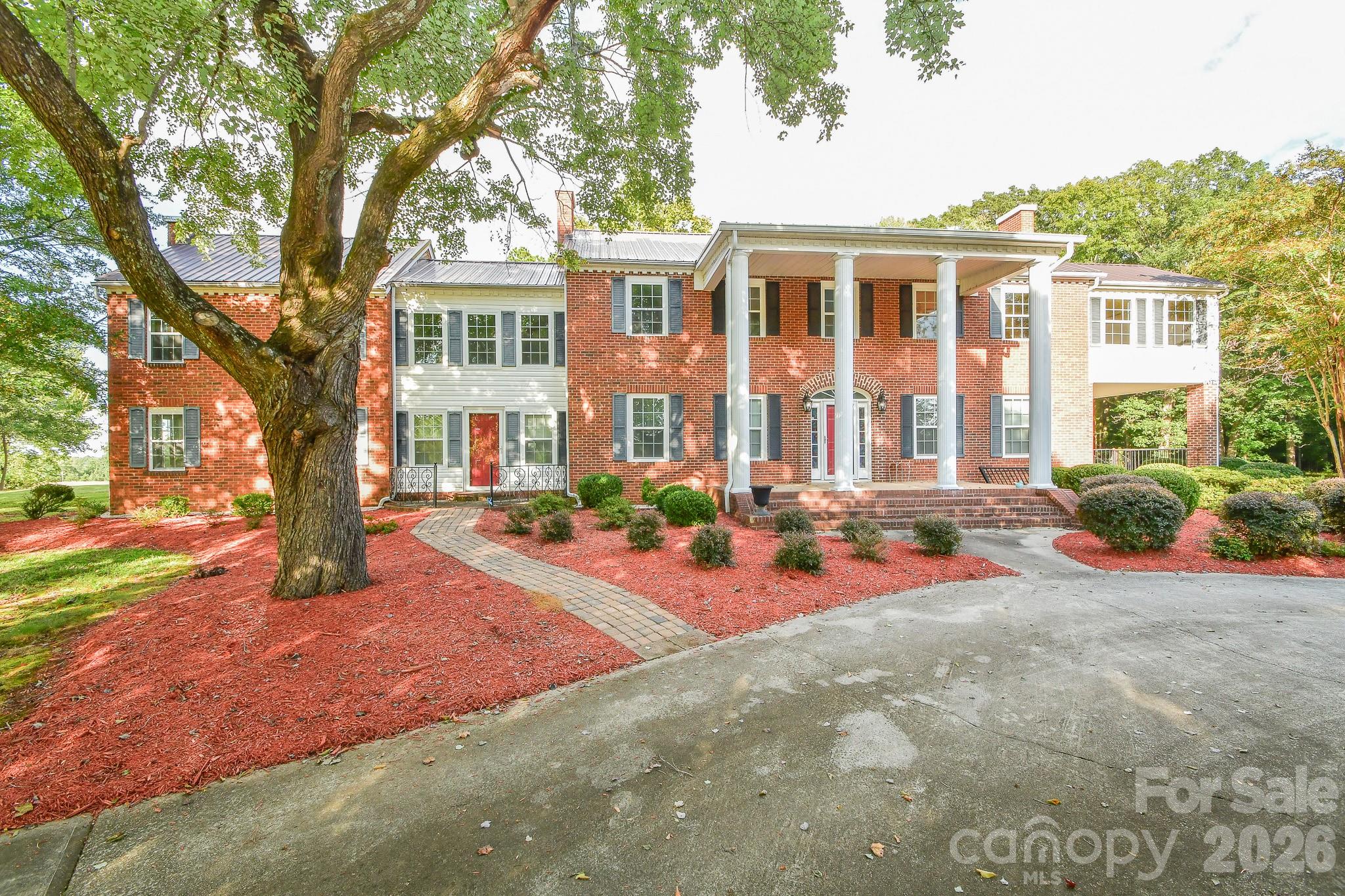 This colonial-style home, constructed in the 1950s, exudes elegance and showcases meticulous attention to detail both inside and out. Nestled on approximately 5 acres, it offers 8 bedrooms, 3 bathrooms, 2 living rooms, a dining room, an oversized flex room, and a spacious basement. Additionally, there is a separate area that can serve as a mother-in-law suite, complete with its own entrance. The side porch and patio provide delightful spaces for entertaining. With remarkable curb appeal. This home is truly timeless! Seize the opportunity to make this piece of history your own!