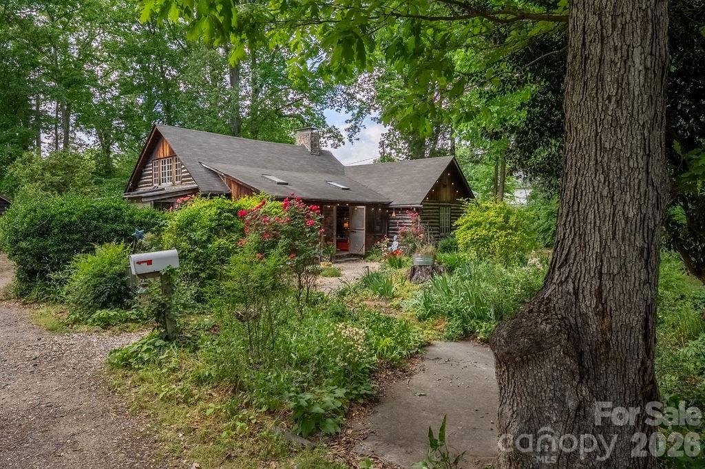 Welcome to a rare and special property in the highly desirable Oakhurst/Amity Gardens neighborhood. Located just 4 miles from Uptown Charlotte, with easy access to public transport, shopping, restaurants and schools, "The Poets Cabin" is nestled on over an acre of very private, natural property. Hand-built with gorgeous solid woods in the early 1930s, here everyday living feels like a peaceful mountain retreat in the heart of Charlotte - a perfect place emphasizing quality of life without sacrificing convenience.

This home offers timeless charm and character at every turn. Come down the natural walkway surrounded by magnificent plants, flowers and trees. Enter the large, screened front porch perfect for outdoor dining and entertaining. Step through the vintage Dutch door adorned with custom ironwork and you’re immediately greeted by soaring ceilings and exposed wooden beams in the family and dining areas creating a light, airy feel. Historic details are thoughtfully preserved throughout, including crank-operated windows, white oak floors and original wall sconces. The large stone fireplace anchors the main living space, complete with decorative iron convection vents and a hearth crane designed for large pots for open fire cooking, an extraordinary nod to the home’s history. A small greenhouse is tucked away off the back of the home for plant enthusiasts.

The generous gardens and stunning woods filled with countless song-birds offer their own unique outdoor living spaces. They invite to plant, take walks, play games, watch nature, listen, rest and meditate. There is a designated fire-pit area and a private well in original well-house that is used mostly for watering. Privacy is further protected by a 15 foot natural area easement on adjacent property. Natural area is noted on survey.

“The Poets Cabin” also boasts a creative pedigree as the Charlotte Repertory Theatre, Charlotte Folk Society, Moving Poets and many others used this home and property for artistic endeavors. For decades, it has been a place for readings, performances, dances, and concerts deeply woven into the Charlotte’s arts and creative community - a place of soul and gatherings. Every room, nook and corner presents an opportunity for livable space encouraging connection.

A separate cabin currently used as an artist studio sits on the property, featuring two large rooms, a fully plumbed bathroom, and an additional space that could easily be converted into a kitchen. Heating and air conditioning in the studio are currently only serviced by a portable HVAC and a dehumidifier, but an additional mini-split system is already purchased and can be installed. This approx 1000 sqft cabin offers excellent potential as a guest house or short-term rental opportunity.

The property also offers significant development potential. It s currently zoned N1-D, which could allow sub-division and the development of single family, duet, trio and quadruplex homes on a minimum lot size of 3500sf in accordance with the relevant regulations.

Due to the complexity of the age of this vintage home, this one of a kind property is being sold “As is." Showings preferred on Saturdays between 12-5 due to work-at-home schedules, but we will do our best to accommodate requests when given 24 hours notice.

Come experience “The Poets Cabin” for yourself, an extraordinary opportunity with a truly storied past and an enduring sense of place. This home is ideal for the discerning buyer who values serenity, natural beauty and the ability to entertain with ease in a central location.
