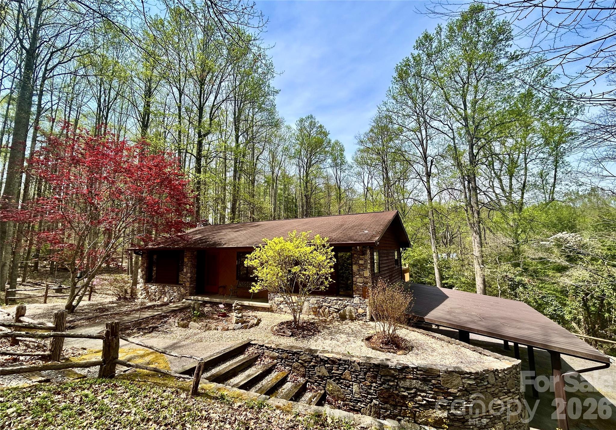 Welcome home to 45 Crescent Point Drive in Hendersonville, offering comfortable main-level living with a versatile finished basement space on a private, wooded lot. This home features three bedrooms and one full bath on the main level, providing a functional and easy-living layout. The kitchen is designed for everyday living, featuring a farmhouse sink, stainless steel appliances and an eat-in dining area conveniently within the kitchen. Natural light fills the main living spaces, creating a warm and welcoming atmosphere throughout the home. The finished basement expands your living options with an additional full bath, family room, laundry area, attached workshop, a bonus room with walkout access. From the lower level, go outside to three covered parking spaces, offering excellent convenience and flexibility for vehicles, hobbies or equipment. Outdoors, enjoy the deck space overlooking the peaceful wooded lot, ideal for relaxation and privacy. A barn-style storage shed adds charm and practical storage for tools, lawn equipment or recreational gear. The property is serviced by a shared well. With some updates, this property can be your quiet oasis on Davis Mountain. This home offers a blend of privacy and functionality. Don’t miss this opportunity to own a versatile property in a desirable Hendersonville location. A portion of Davis Mtn Road is closed with work projected to start April 2026. Discover 45 Crescent Point Drive today!