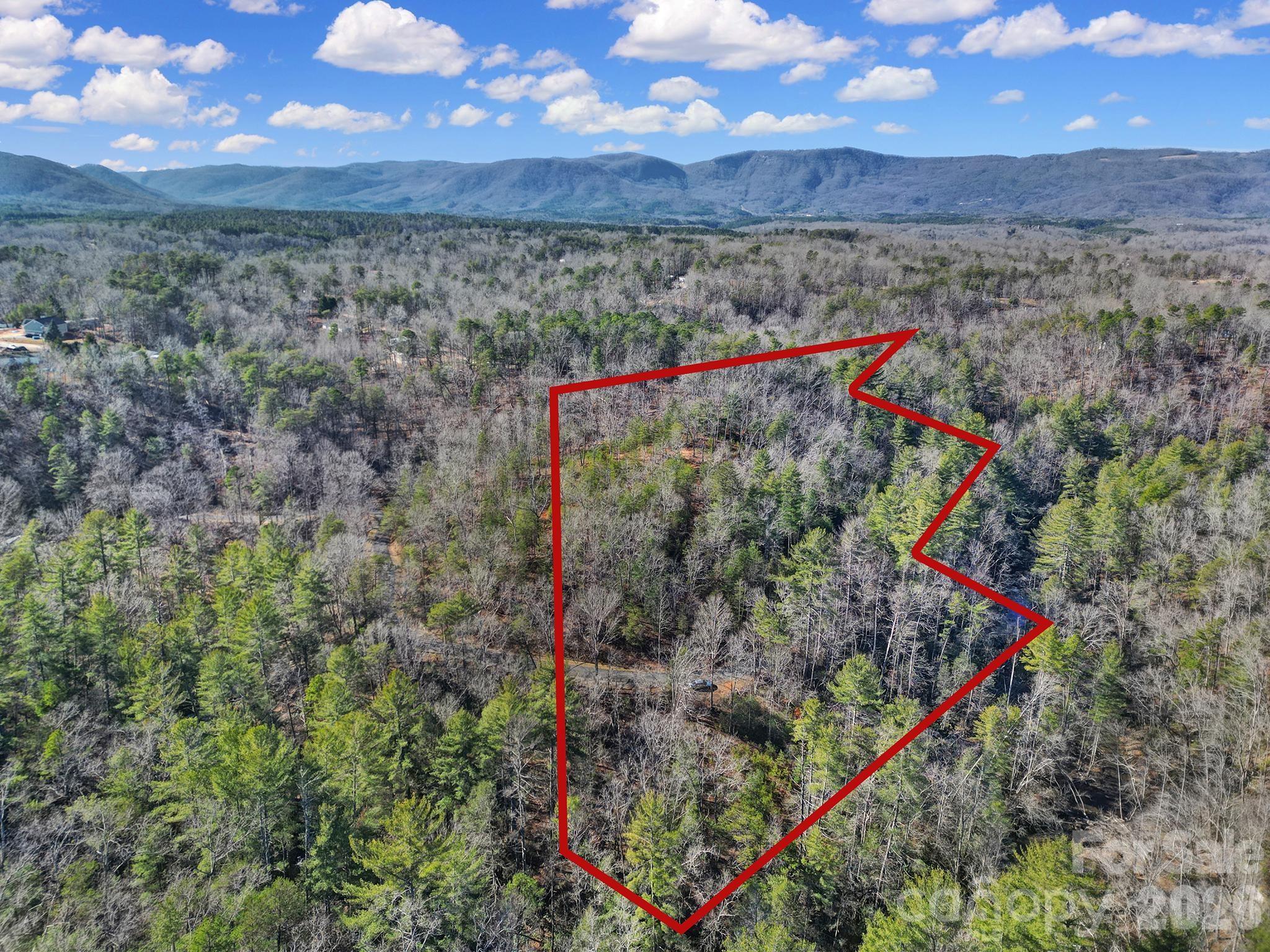 Nestled within the Lake Adger community, this 4.45-acre wooded homesite offers a rare opportunity to build your mountain retreat along the banks of beautiful Ostin Creek. With approximately 500+ feet of creek frontage, the property features mature hardwoods, natural rock formations, and a gently sloping terrain ideal for a private, site-built home overlooking the water.
Located in the Highland Farms section of Lake Adger, the lot provides a secluded setting while still offering convenient access to community amenities including Lake Adger Marina, walking trails, and nearby recreation. Enjoy kayaking, boating, fishing, and easy access to the Green River for tubing and trout fishing.
Architectural guidelines preserve the natural beauty of the area, and underground utilities are available. Private, gravel and paved road access leads directly to the property. No city taxes. HOA maintained roads and common areas.
A peaceful mountain setting just a short drive to Columbus, Tryon, and Asheville—ideal for a primary residence, second home, or nature-focused getaway.