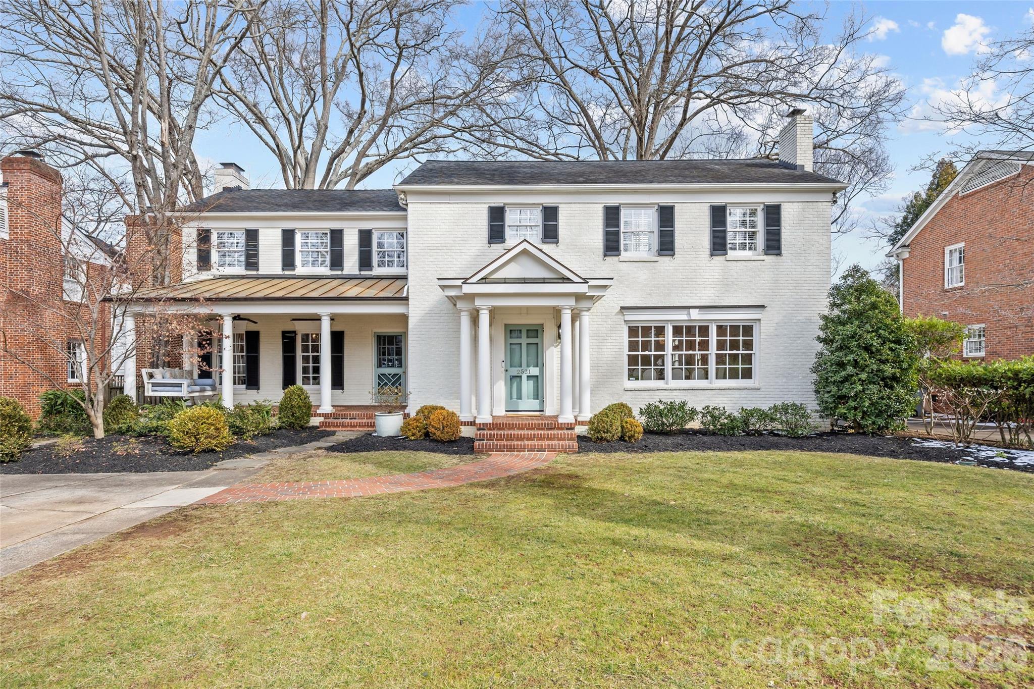 Situated on Hampton Avenue in the heart of Myers Park, this beautifully updated 4-bedroom, 3.5-bath traditional home is completely move-in ready and thoughtfully designed. The desirable open floor plan features hardwood floors, ornate custom moldings, and tasteful finishes throughout. Formal living and dining rooms each with gas fireplaces provide the perfect space for entertaining, while the expansive kitchen serves as the centerpiece of the home with white custom cabinetry, quartz countertops, center island, and high-end stainless appliances including a Wolf gas range and Sub-Zero refrigerator. The kitchen flows seamlessly into the sprawling dining area and family room, offering exceptional flexibility for everyday living. Additional highlights include a private office with built-ins and spacious laundry room/drop zone with abundant storage. Upstairs offers a serene primary suite with fireplace, walk-in closet, and spa-inspired bath plus three secondary bedrooms and bonus room. Outdoors, enjoy a fully fenced, turfed backyard with mature landscaping, spacious brick patio, outdoor fireplace, and built-in grilling station. Ideally located near Uptown and SouthPark, this home blends classic charm with modern comfort.