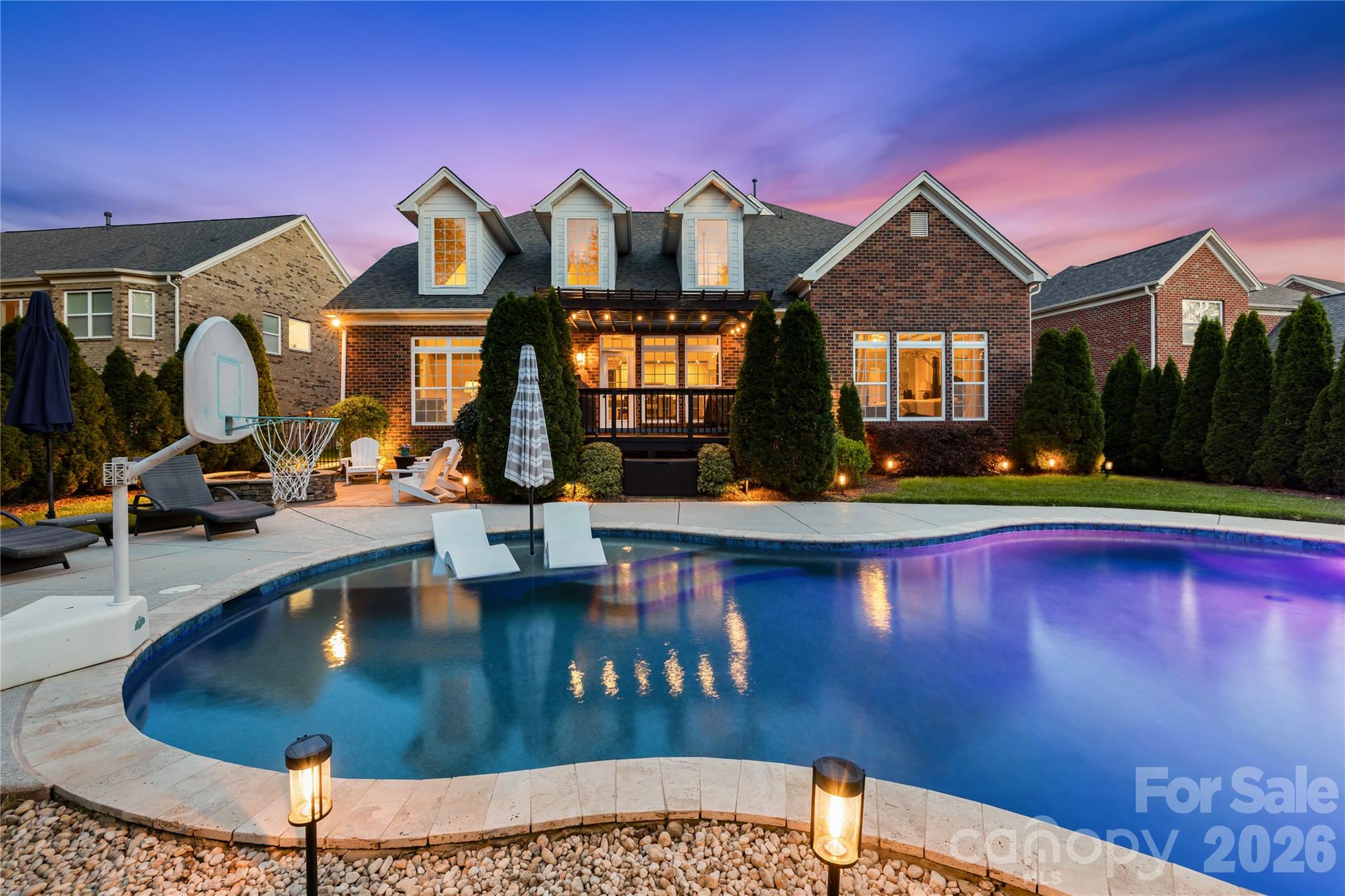 If you are looking for a well maintained full brick home in the top rated Marvin Ridge school cluster look no further.  This Shea Homes Alpine model will check all of your boxes.  From the outdoor oasis with inground salt water pool with tanning ledge, patio with gas fire pit, fenced and private backyard to the the wonderful open floor plan, you will want to call this one home.  The heart of the home is perfect for entertaining.  The kitchen has an approximately 12 foot breakfast bar that opens to the dining area and family room.  The counter depth stainless steel refrigerator in the kitchen will remain.  There is a stacked stone fireplace in the dining area.  Off the front foyer is an office with french doors.  Opposite the office is the designated formal dining room with tray ceiling and chairs rail.  The primary bedroom with attached primary bath is on the main level.  The primary bathroom features his and her vanities and walk in closets with built ins.  There is a jacuzzi tub and walk in shower.  The entire main level is hard wood floors!  Moving upstairs you will find the loft.  This area is perfect for homework/office/craft area or simply a reading nook.  3 good sized bedrooms with 2 full bathrooms are on the upper level.  Closets have built in systems.  There are french doors leading to a huge bonus room.  Off the bonus room is another flex space.  Again you will find wood floors throughout the upper level with the exception of the flex/playroom.   Both HVAC units have been replaced, new tankless gas hot water heater and new architectural shingle roof.   Residents of Barrington enjoy resort-style amenities, including a large pool, clubhouse, tennis and basketball courts, a playground, and scenic walking trails. The home is located minutes from downtown Waxhaw where you can enjoy the town activities like parades, Friday night music under the water tower, Farmer's market along with  plenty of restaurants and local shops.  Located a short distance from Blakeney, Ballantyne and the 485 corridor.