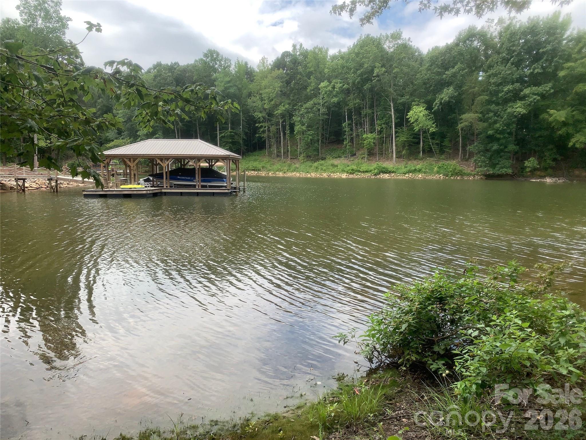 One of the few remaining waterfront lots in Shavenders Bluff. This lot is .99 acres and includes a Highly Sought After deeded boat slip walking distance from your front door. Community amenities include a waterfront park with beach access, picnic area, boat launch, boat storage, pool, and walking trails. Excellent location in a quiet community, just minutes away from dining, shopping, major medical, and interstate access.  Use your own builder, no time frame to build. Lot is perfect for a walkout basement build with a pool overlooking Lake Norman, as the septic is on an off site lot included in the sale.