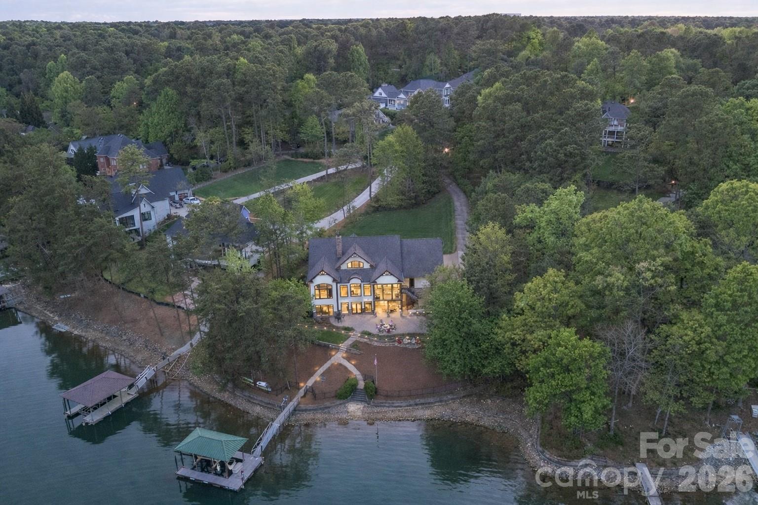 If you’re chasing the best views on Lake Norman, you just found them.

Perfectly positioned on a premier main channel lot within Northview Harbour, this exceptional waterfront estate captures commanding, panoramic lake views that are simply second to none. From the moment you arrive, the setting is unmistakable—this is true Lake Norman living, where every room and every outdoor space is designed to maximize the water, the light, and the lifestyle.

Inside, soaring vaulted ceilings with custom wood beam detail create a dramatic yet inviting great room, anchored by walls of windows that frame the lake like artwork. The open-concept design flows effortlessly into a beautifully updated chef’s kitchen featuring quartz countertops, marble backsplash, premium appliances, and an expansive island built for gathering.

The main-level primary suite offers a private retreat with a spa-inspired bath, while the upper and lower levels provide generous accommodations for guests, entertaining, and flexible living. The fully finished lower level opens seamlessly to the outdoors, creating the ideal extension of living space.

Step outside and experience what truly sets this property apart. A stunning screened porch overlooks the main channel, offering year-round enjoyment of the water. Below, an expansive custom paver patio with built-in grilling station, fire pit, and multiple seating areas creates a resort-style environment designed for entertaining or quiet evenings by the lake.

The gently sloping, professionally landscaped yard leads to a private waterfront oasis, complete with an updated composite dock, covered structure, and high-capacity boat lift—making lake access effortless and immediate.

Meticulously maintained with extensive updates throughout, this home offers not only luxury but peace of mind. Set on a quiet cul-de-sac in one of Lake Norman’s most desirable communities, you’ll enjoy privacy, craftsmanship, and convenience—all just moments from shopping, dining, and everything the area has to offer.

This is more than a home—it’s a statement property, defined by its views, its setting, and the lifestyle it delivers.