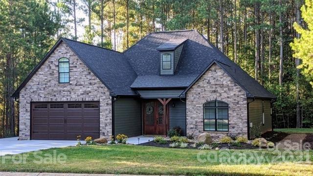 Enjoy lake living in this exclusive gated community at Sunset Pointe. This luxurious 3 BD 2 BA dream home boasts exposed wooden beams, soaring cathedral ceiling & features a beautiful stone fireplace in the great room. Open floorplan has resilient water proof luxury vinyl planking throughout. Kitchen features granite counters, tiled back-splash, & matching print free appliances. Check out the primary ensuite w/ tray ceiling, dual closets, tiled walk-in shower & vanity w/double sinks & granite top. Arched windows have been accented by custom high end plantation shutters. Screened porch leads out to stone pavers w/built in seating & wood burning firepit. The community amenities offer club house, fitness center, swimming pool, tennis/pickleball court, basketball court, playground & a convenient community boat ramp for quick access to High Rock Lake which is the 2nd largest lake in NC w/ 365 miles of shoreline. Come be a part of this great community while living in a gorgeous dream home!!