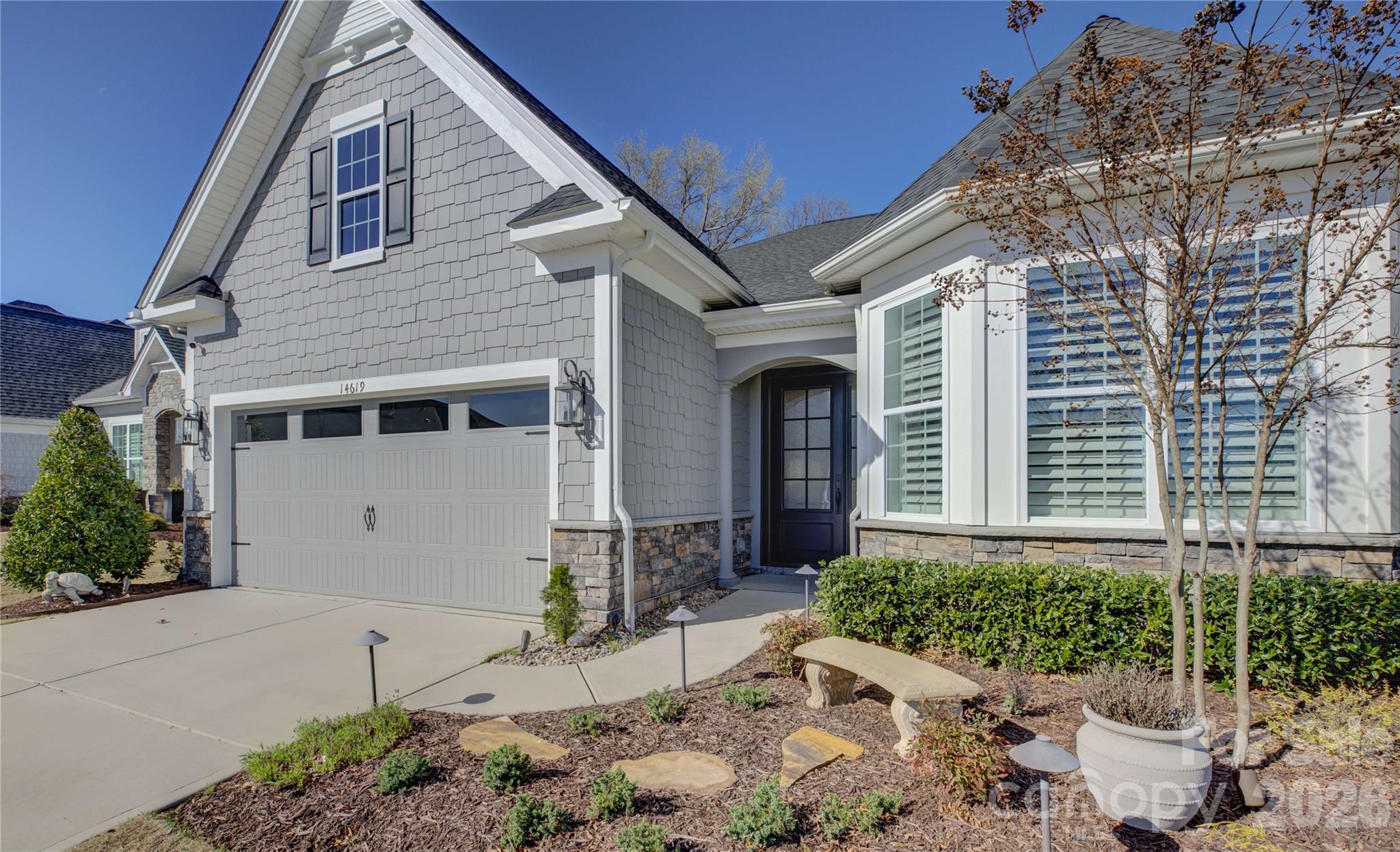 Located in the amenity-rich Regency at Palisades neighborhood, this meticulously maintained home is filled with thoughtful upgrades and custom details that make it a true standout. A striking custom steel front door welcomes you into an interior adorned with rich wood flooring, custom plantation shutters, and designer drapery panels throughout. Just off the entry, a private study or formal living room offers a quiet retreat. The open-concept layout seamlessly connects the gourmet kitchen, dining area, and living room, creating an ideal space for everyday living and entertaining. The stunning kitchen features crisp white cabinetry, a large prep island with a single-bay sink, a gas cooktop, a wall oven, an eye-catching tile backsplash, and beautifully customized pantry and butler’s pantry cabinetry. Sliding glass doors with a remote-controlled blind lead to a screened porch with cool travertine flooring, perfect for year-round enjoyment, overlooking a stone patio and a backyard enhanced with tasteful garden lighting and French drains. The oversized primary suite is a serene escape with a tray ceiling, dual vanities, a glass-enclosed tiled shower, and an impressive custom closet. A well-appointed laundry room with a utility sink, folding counter, and additional custom cabinetry makes daily tasks a pleasure, while two spacious secondary bedrooms share a hall bath. This exceptional home blends comfort, function, and elegance in every detail.