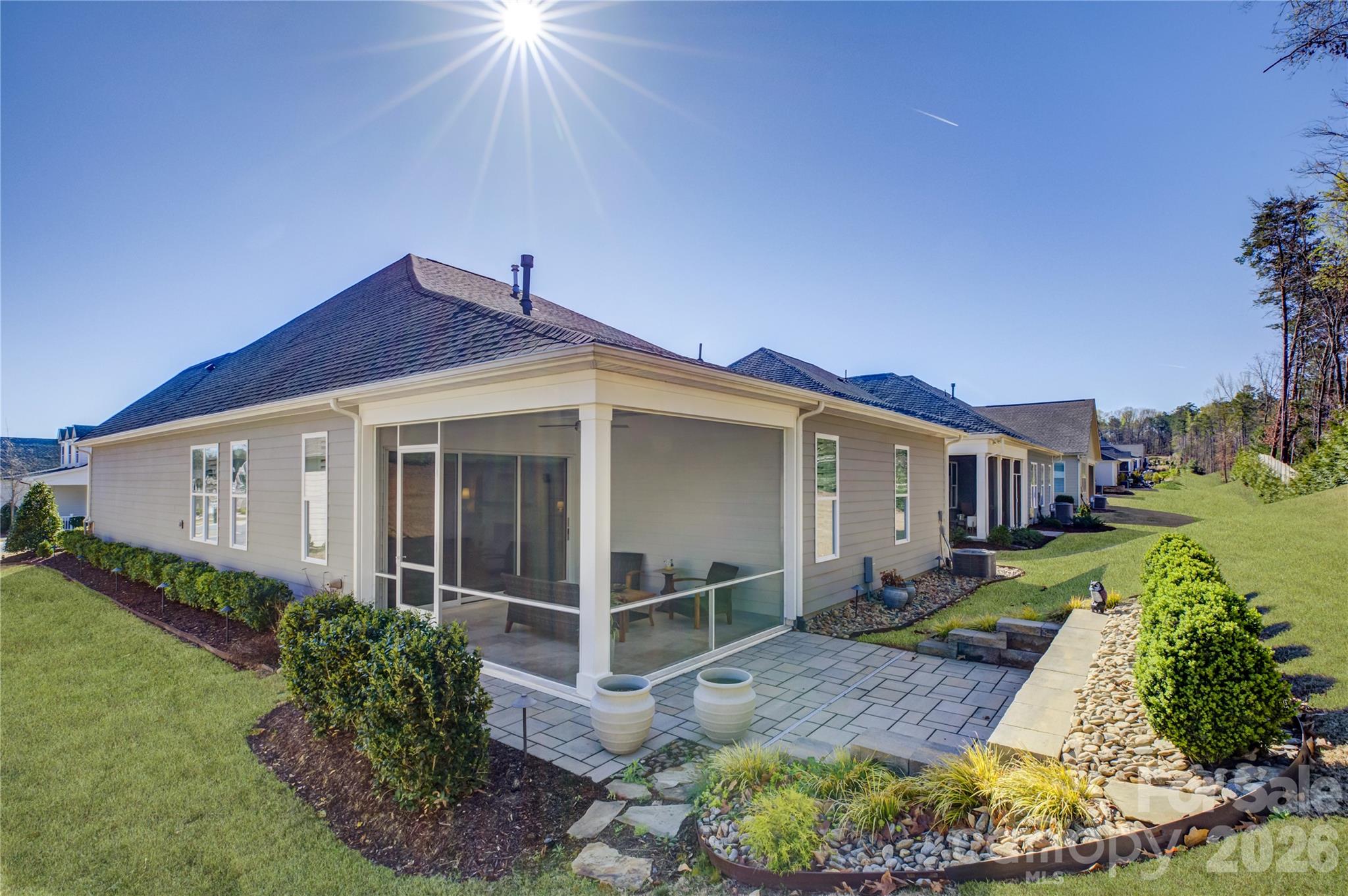 Located in the amenity-rich Regency at Palisades neighborhood, this meticulously maintained home is filled with thoughtful upgrades and custom details that make it a true standout. A striking custom steel front door welcomes you into an interior adorned with rich wood flooring, custom plantation shutters, and designer drapery panels throughout. Just off the entry, a private study or formal living room offers a quiet retreat. The open-concept layout seamlessly connects the gourmet kitchen, dining area, and living room, creating an ideal space for everyday living and entertaining. The stunning kitchen features crisp white cabinetry, a large prep island with a single-bay sink, a gas cooktop, a wall oven, an eye-catching tile backsplash, and beautifully customized pantry and butler’s pantry cabinetry. Sliding glass doors with a remote-controlled blind lead to a screened porch with cool travertine flooring, perfect for year-round enjoyment, overlooking a stone patio and a backyard enhanced with tasteful garden lighting and French drains. The oversized primary suite is a serene escape with a tray ceiling, dual vanities, a glass-enclosed tiled shower, and an impressive custom closet. A well-appointed laundry room with a utility sink, folding counter, and additional custom cabinetry makes daily tasks a pleasure, while two spacious secondary bedrooms share a hall bath. This exceptional home blends comfort, function, and elegance in every detail.