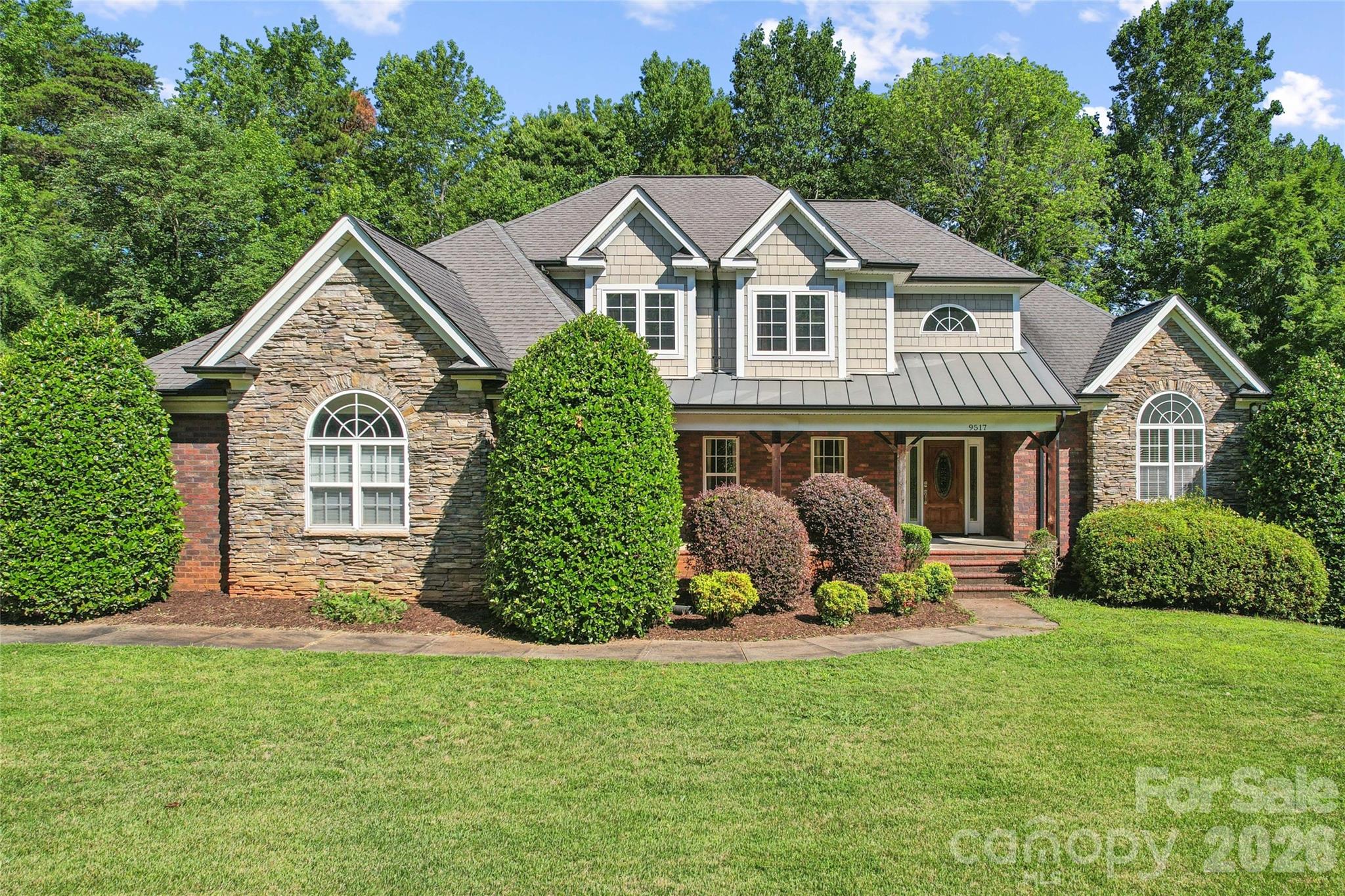 Mint Hill locale spacious 4 BR + office brick 1.5 story on nearly half acre lot. Private rear deck with new vinyl railings. Primary Bedroom and Jacuzzi full bath on main level. Solid surface counters and plenty of cabinet space in open kitchen / dining. Vaulted to 2nd floor great room with gas logs fireplace. Arched columns in great room.  Private rear deck. 3 car attached garage. Lots of extra driveway parking area in addition to 3 car attached garage. Walk-in, floored 317 sqft attic area.