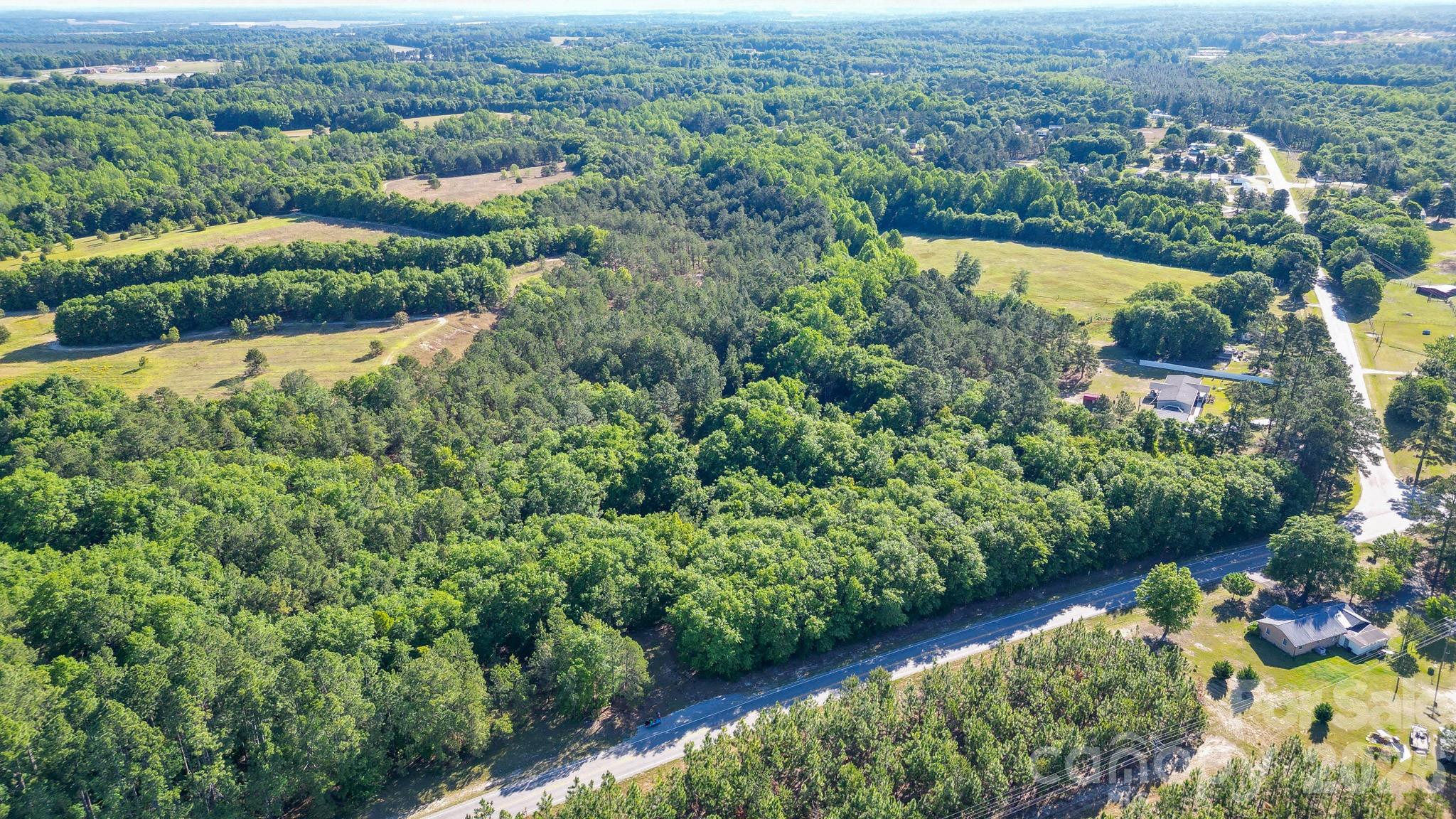 BACK UP OFFERS ACCEPTED> Discover the perfect blend of nature and opportunity with this expansive 26.2-acre parcel of wooded, unimproved land located in the charming town of Pageland. This property offers a diverse mix of pines and hardwoods, providing a private setting & tranquil environment, perfect for those seeking a peaceful retreat or a nature-inspired development.  This unimproved land is a blank canvas waiting for your vision. The mix of pines and hardwoods not only enhances the property's aesthetic appeal but also offers potential timber value. With over 800 feet of road frontage, this property ensures easy access and visibility, making it ideal for various uses.  Whether you're looking to build a private residence, establish a recreational area, or invest in timber, this land provides endless possibilities. County water is available on Airport Rd. Zoning is General Development. Property is under a contingent purchase agreement.  Backup offers are welcomed by the seller. A home with additional acreage is available for sale. **Total closed sale included parcels 046-000-000-044, 046-000-000-045, 046-000-000-046.