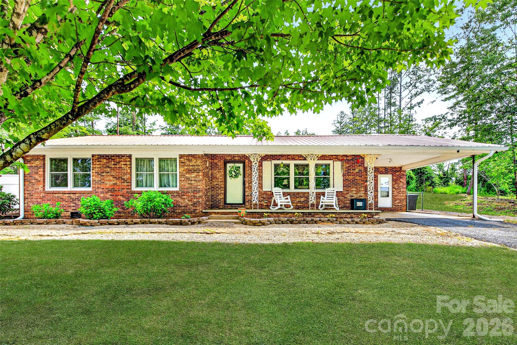 *Charming Well-Maintained Brick Home on 4.45 Unrestricted Acres**
Discover this inviting 1,641 sq ft brick home featuring 3 spacious bedrooms and 2 bathrooms, nestled in a tranquil country setting. Enjoy seamless main-level living, complete with a generous living area, a kitchen, and a dining space adorned with French doors that open to a covered back patio, perfect for entertaining and relaxation. The master bedroom offers an en-suite bathroom and a walk-in closet, while the other bedrooms provide ample space for comfort. The laundry/utility room boasts plenty of cabinetry for convenient storage. Beautiful hardwood floors enhance most areas of the home. Additional highlights include an attached carport and a lovely covered front porch with views of the serene surroundings. Located on a low-traffic road, this home is equipped with a heat pump for heating and cooling, complemented by a backup propane heater. The property also features a shed/workshop with a covered area ideal for ATVs, lawn equipment, and personal projects. With its unrestricted land, the possibilities are endless for building, farming, adding outbuildings, and it has potential for subdivision. High-speed internet is available. Well and septic. Experience the breathtaking beauty of the Western NC Mountains and enjoy an abundance of outdoor activities, including hiking trails, lakes, waterfalls, boating, and fishing. Your dream country retreat awaits!
