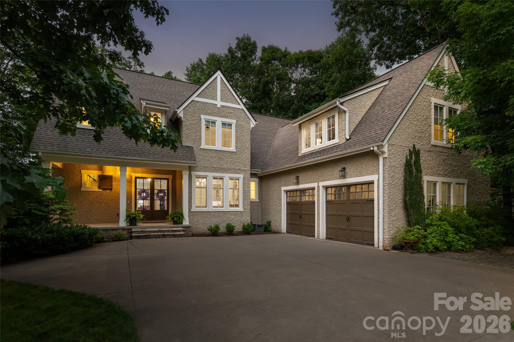 Welcome to your mountain retreat in the prestigious gated community of Southcliff. Ideally located just outside Asheville's city limits, this exceptional home offers the perfect balance of privacy, natural beauty, and convenience—just minutes from vibrant downtown Asheville and the Blue Ridge Parkway. Inspired by the timeless Tudor Revival architecture of Biltmore Village, this beautifully renovated residence showcases mountain views and thoughtfully curated living spaces throughout.

The light-filled interior features an open-concept floor plan designed for both everyday living and effortless entertaining. The chef's kitchen is appointed with quartz countertops, a gas cooktop, updated designer lighting, abundant cabinetry, and generous prep space. The spacious main-level primary suite serves as a private retreat, complete with a beautifully renovated spa-inspired bath featuring a soaking tub and refined finishes.

Upstairs, you'll find well-appointed guest bedrooms along with flexible living spaces ideal for a home office, playroom, or media lounge. The finished walk-out lower level expands the home's versatility with a dedicated home theater, fitness room, additional office, and abundant storage.

Step outside to a beautifully landscaped backyard where a flagstone patio overlooks Southcliff's protected conservancy, creating a peaceful, private setting surrounded by nature. Miles of hiking trails, community parks, and breathtaking mountain scenery are just beyond your doorstep, offering the exceptional mountain lifestyle that makes Southcliff one of Asheville's most sought-after communities.