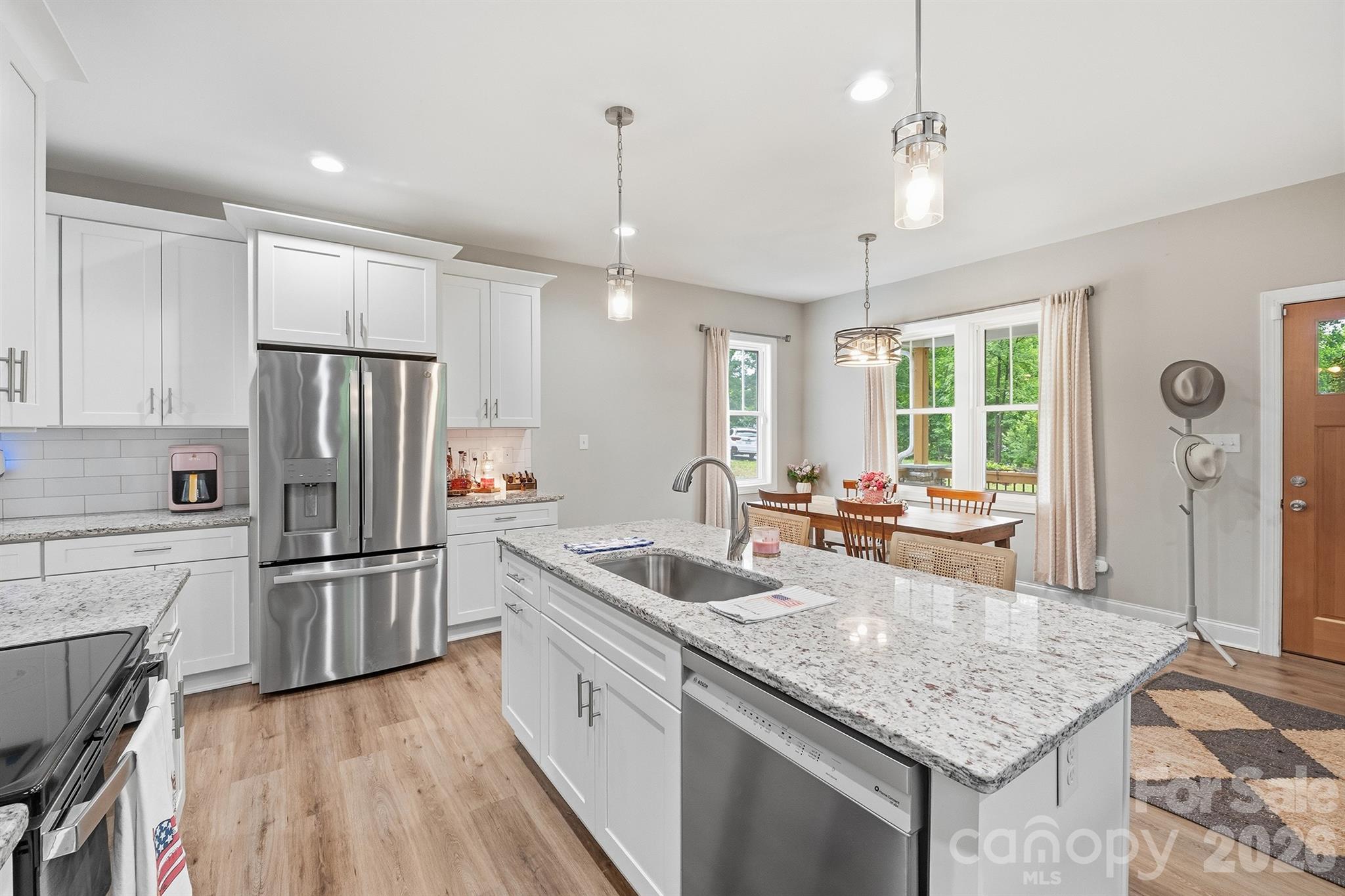 Built in 2022, this well-kept home is perfect for anyone looking for low-maintenance living without sacrificing comfort. Located within the city limits, you'll be close to the hospital, shopping, restaurants, and everyday conveniences.The main-level primary suite features a walk-in shower and double sinks. Enjoy your morning coffee on the covered front porch with a nice view, while the stacked stone columns add great curb appeal.
The kitchen offers granite countertops, a large island, and an open layout that's great for everyday living. You'll find LVP flooring on the main level and carpet upstairs.The fully fenced backyard is ideal for pets, kids, or relaxing outside, and the one-car garage provides extra storage. If you've been looking for a newer home with a smaller yard, no HOA, and a great location in the city limits, don't miss this one!
