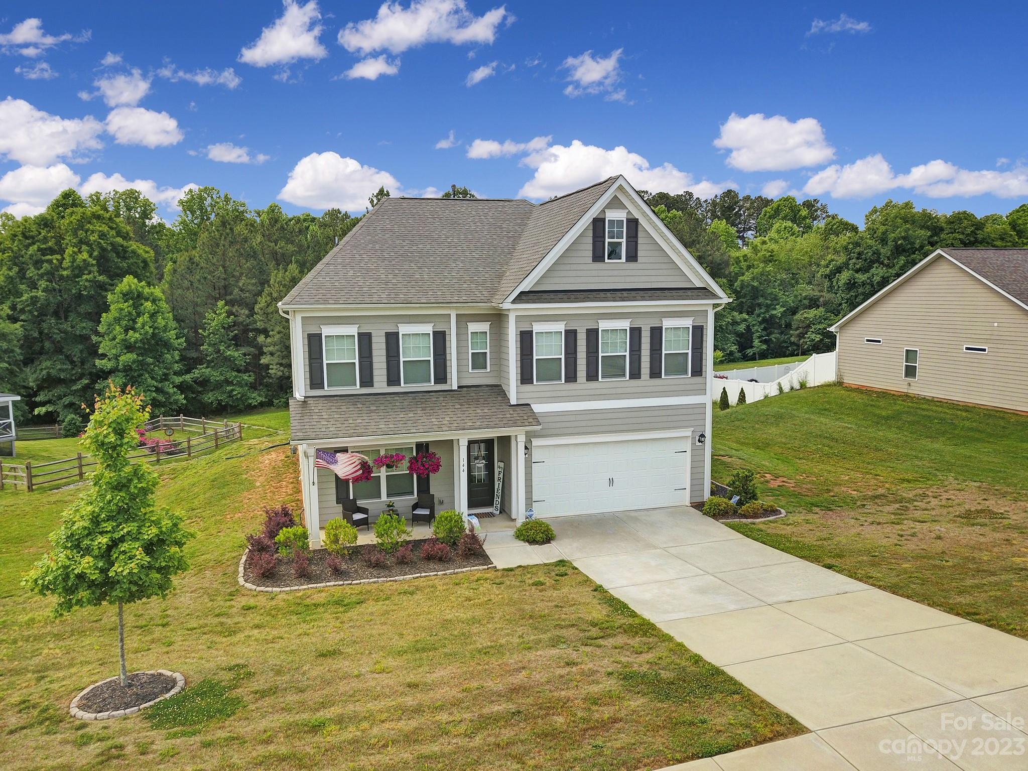 Looking for a newer home on a LARGE lot? Built in 2019, this lovely two-story home is situated on a spacious .74 acre lot in the desirable Autumn Brook community. Rocking chair front porch welcomes you into this open layout with wood floors, neutral paint & crown molding. Kitchen features staggered Shaker cabinets, granite countertops, subway tile backsplash, island with seating, walk-in pantry, butler’s pantry & adjacent breakfast area. Dining room offers plentiful natural light & beautiful trim work. Family room includes a gas fireplace. Office or could be used as a bedroom since there's space to add a closet. Expansive primary bedroom with a sitting area & ensuite that includes a vanity with dual sinks, separate shower, soaking tub & walk-in closet. Two additional bedrooms, two full bathrooms & a loft. Large, tree-lined yard with a deck. Mud room with built-in bench & two-car attached garage. Convenient to I-77, downtown Troutman & Lake Norman State Park with lake access.