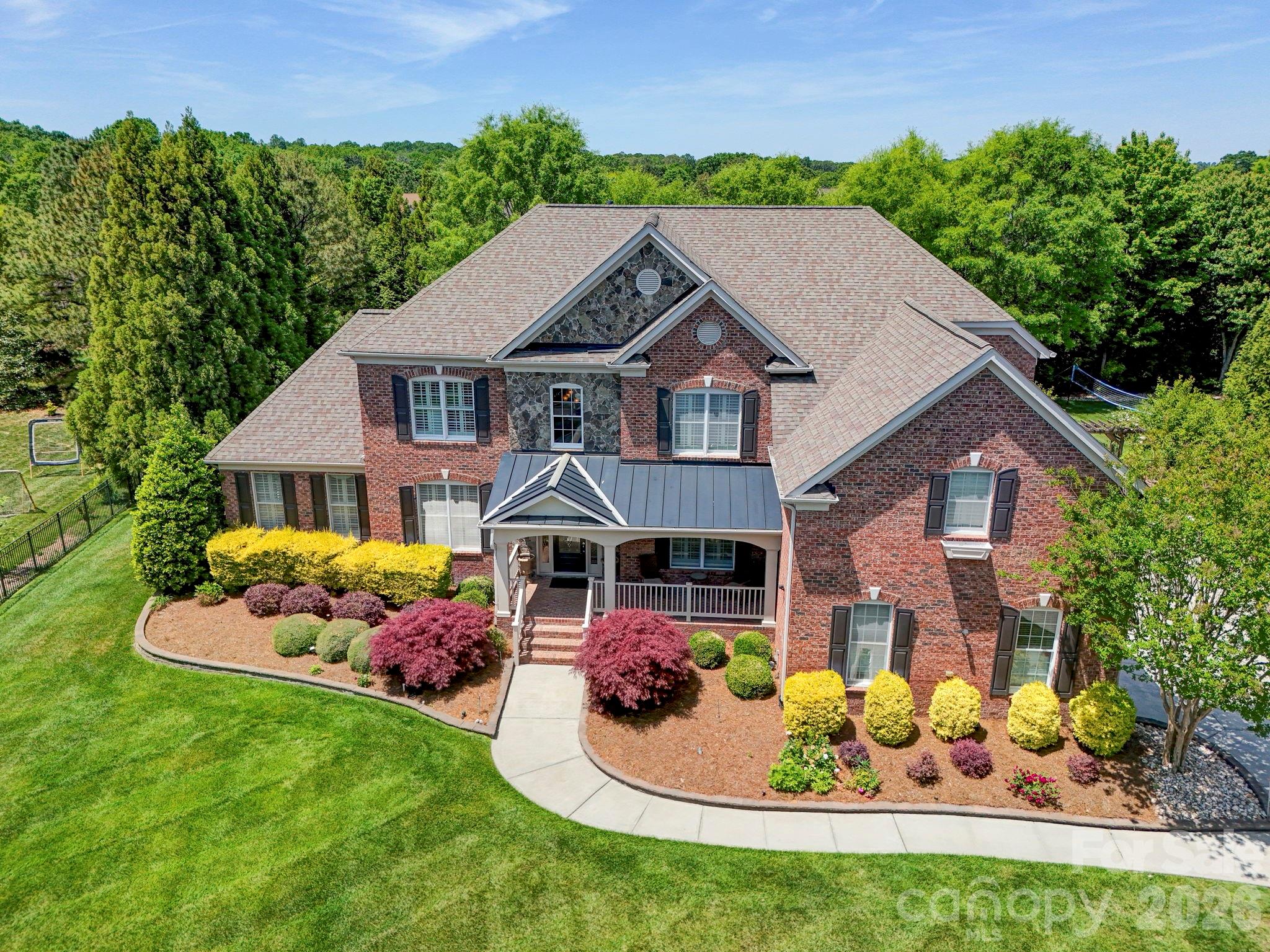 Welcome Home to refined luxury in the highly sought-after Marvin Creek community. Situated on a quiet cul-de-sac, this exceptional residence offers over 6,700 square feet of thoughtfully designed living space, complete with a fully finished basement and inviting outdoor areas that create a true retreat.

This elegant 5-bedroom, 5.5-bath home features an open-concept layout with hardwood floors flowing throughout. The main level includes a private in-law suite with its own sitting room—perfect for guests or multi-generational living—as well as a dedicated office just off the impressive two-story great room, ideal for working from home in style.

At the heart of the home, the expansive kitchen is designed to impress, showcasing a large center island, granite countertops, stainless steel appliances, and abundant cabinetry for both everyday living and entertaining.

Upstairs, the grand primary suite offers a luxurious escape with its own sitting/TV area and a unique hallway leading to three custom closets, providing exceptional storage and organization. Additional bedrooms are generously sized, each offering comfort and privacy.

The fully finished basement spans over 2,000 square feet and is an entertainer’s dream—featuring a pool table area, wet bar, video game space, exercise area, and additional room ready to be transformed into a home theater or customized to your needs.

Step outside to enjoy seamless indoor-outdoor living with a spacious porch and an expansive patio complete with a pergola. The fenced backyard is both private and picturesque, lined with mature cypress trees and complemented by a fruit tree—creating a peaceful and inviting setting.

This home truly embodies the pinnacle of comfort, space, and elegance in one of the area’s most desirable communities.