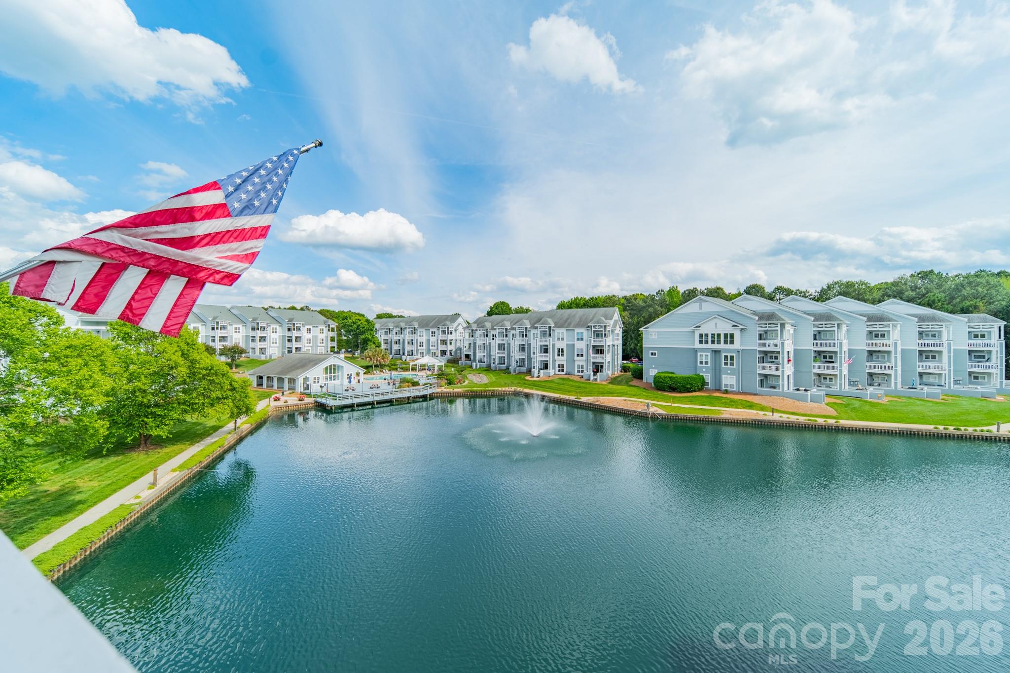 You will love sitting on your 100 square foot (+/-) covered deck looking out over the large community pond with fountains and the community pool area, which is just close enough to easily enjoy it, but just far enough that you won't be worried about noise.  Stroll over to enjoy beautiful Lake Norman, and maybe even launch your kayak. Grab your racket for a quick game of tennis or pickleball. Feel like a quick bite and/or entertainment at a local restaurant / hot spot? - be there in about 3-5 minutes!  More in the mood for metro Charlotte? Hop on I-77, and be there in no time.  While you are here at home, you will truly appreciate the updated kitchen with GORGEOUS counters which provide plentiful work area plus space for additional seating. Electric range new in 2025, has downdraft, air fry, dehydrate, steam clean and bread proofing. Microwave also new in 2025.  The very nice electric fireplace isn't just for looks ... it also provides heat. Water and sewer included in HOA dues. No vacation rentals means this feels more like home, and protects your peace and your value.  Exterior was just painted Spril 2026. The HOA docs reference fiber cement, but seller isn't sure.  Photographer had to postpone, but we should have photos uploaded for you to see by Friday.  Stay tuned!