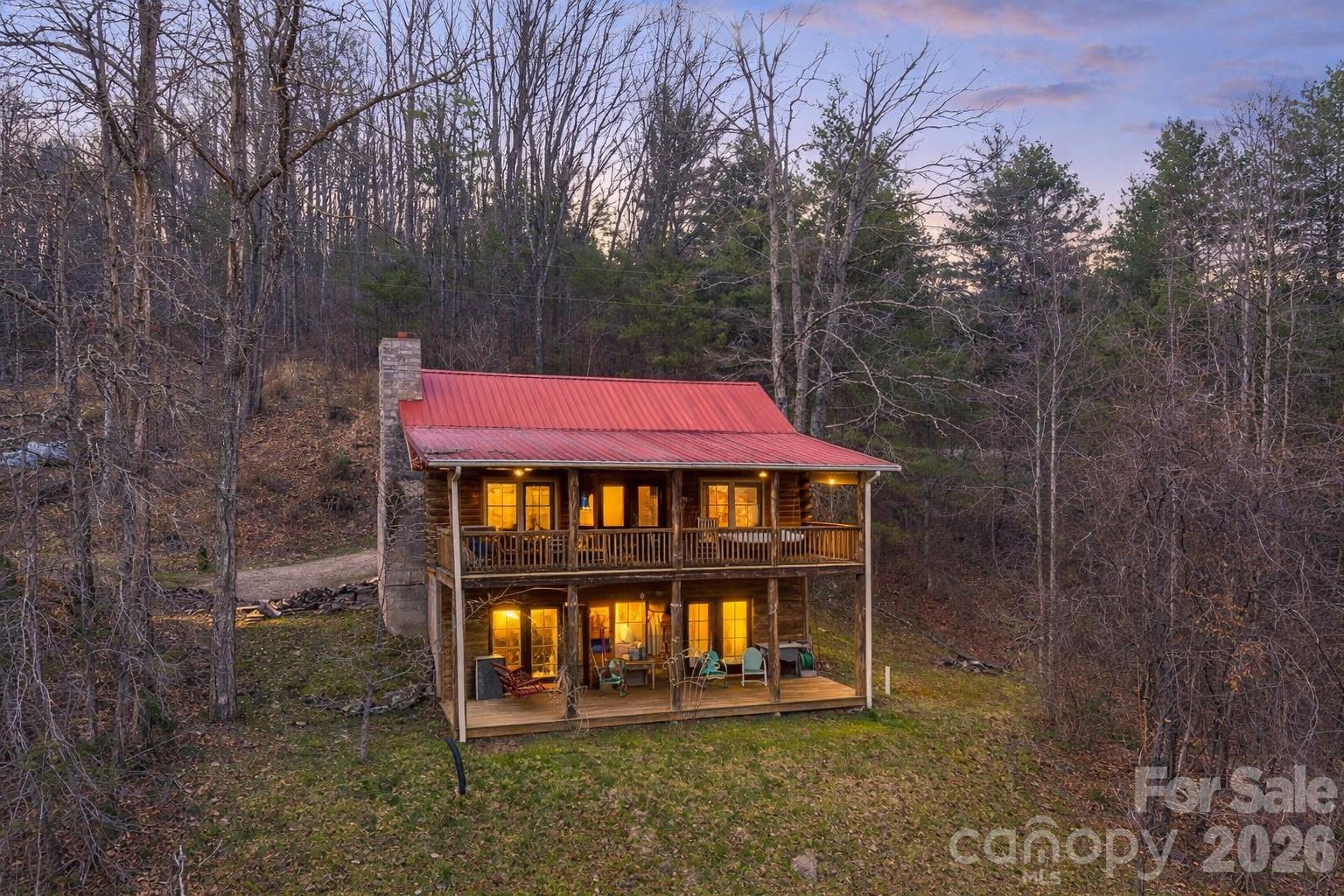 Welcome to your mountain cabin—whether you’re searching for a short-term rental, primary residence, or second home, you’ll be sure to appreciate the charm, comfort, and beautiful long-range views this property offers.

Built in 2005 and well maintained, this log cabin blends rustic character with functional living. The main level features an open-concept kitchen, dining, and living area filled with natural light, centered around a stunning fireplace that can be enjoyed from all three spaces. The primary bedroom and full bath are also conveniently located on the main level. Downstairs, you’ll find a second living area, two additional bedrooms, and a full bath, plus walk-out access—ideal for guests or maximizing rental potential.

Step outside onto multiple covered porches and decks, perfect for relaxing, entertaining, and taking in the mountain scenery. The home is being sold furnished (with some exceptions) and includes appliances such as washer and dryer, making it move-in or rental ready.

With a strong short-term rental history and a layout that works for both personal use and guests, this property offers flexibility and opportunity in one of Western North Carolina’s most sought-after settings.

Conveniently located between Asheville and Burnsville for easy access to dining, shopping, and outdoor recreation.